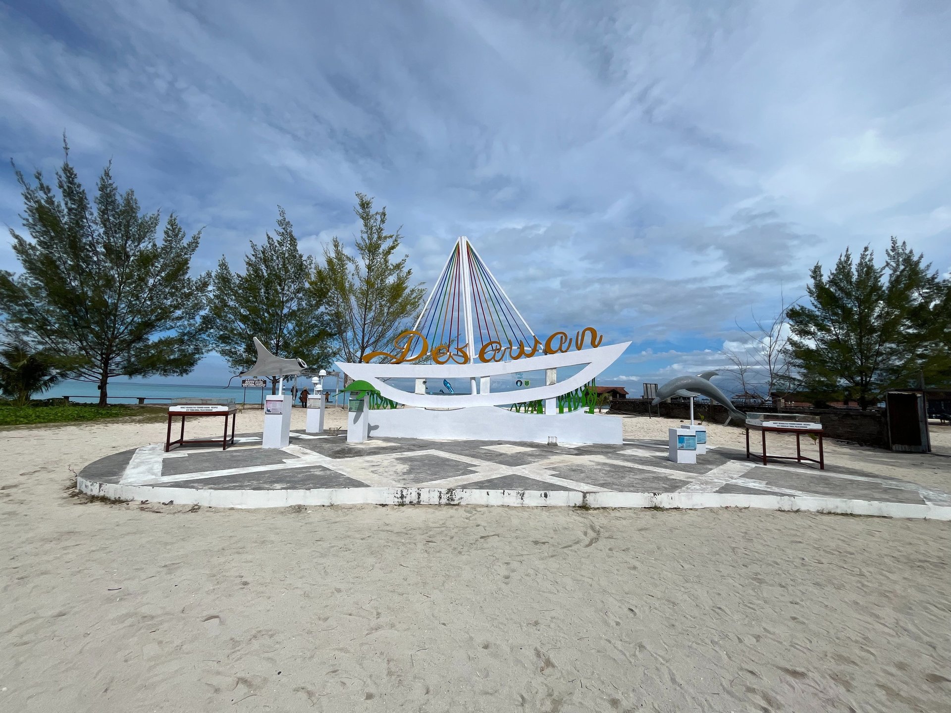 silhouette of trees near body of water during sunset