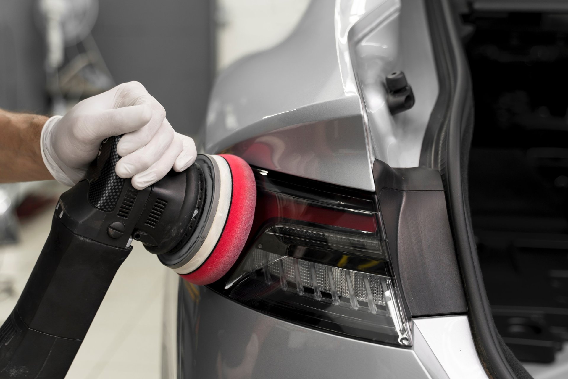 a man with a glove on his hand is changing the tire of a car