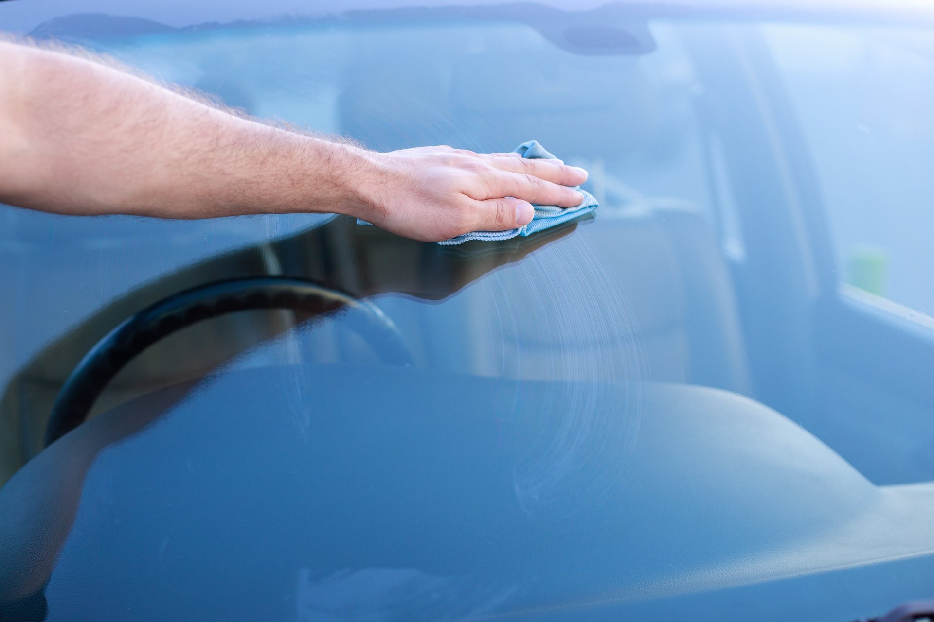 a man with a glove on his hand is changing the tire of a car