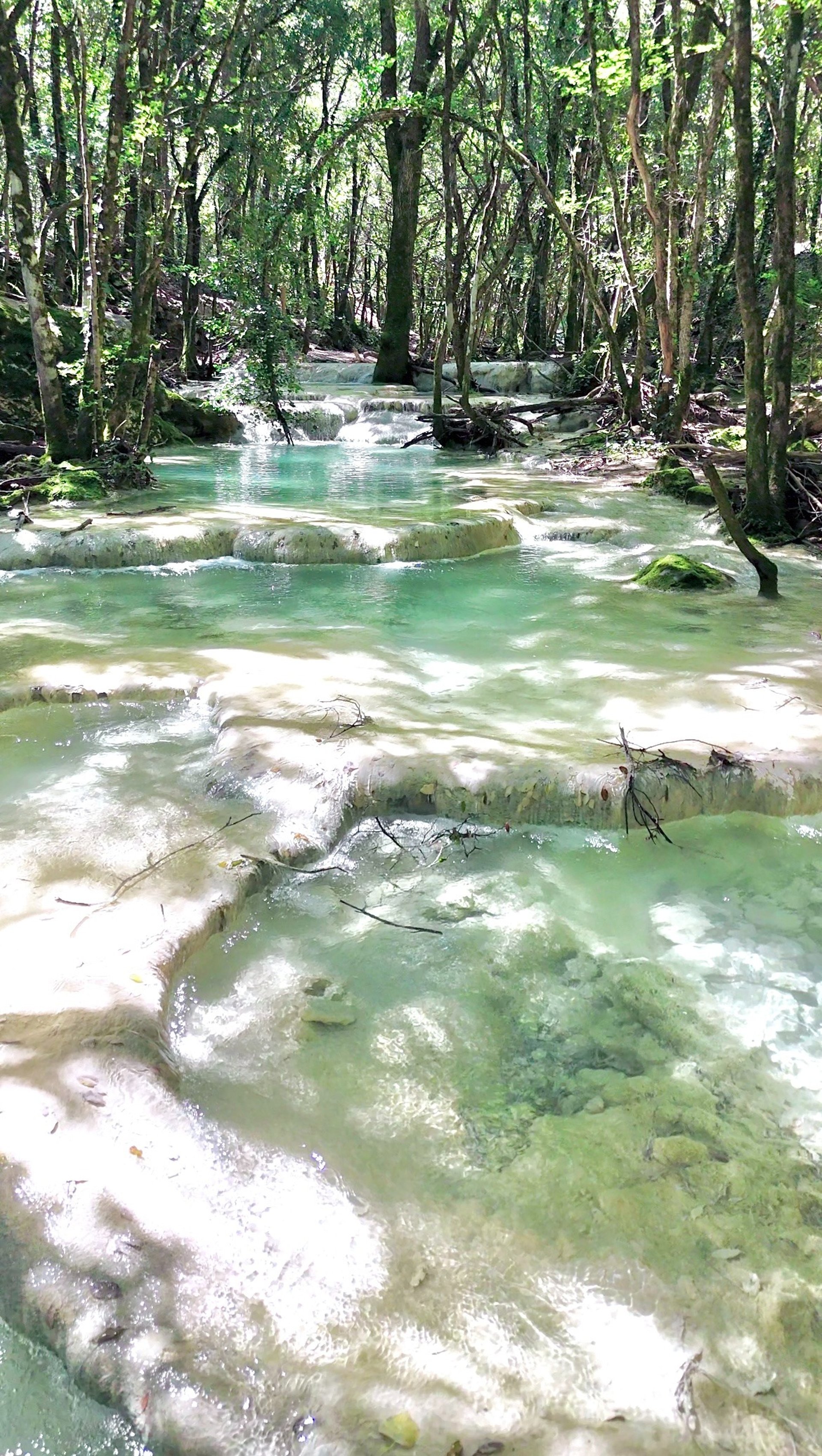 waterfalls on green and gray mountain under white clouds and blue sky during daytime