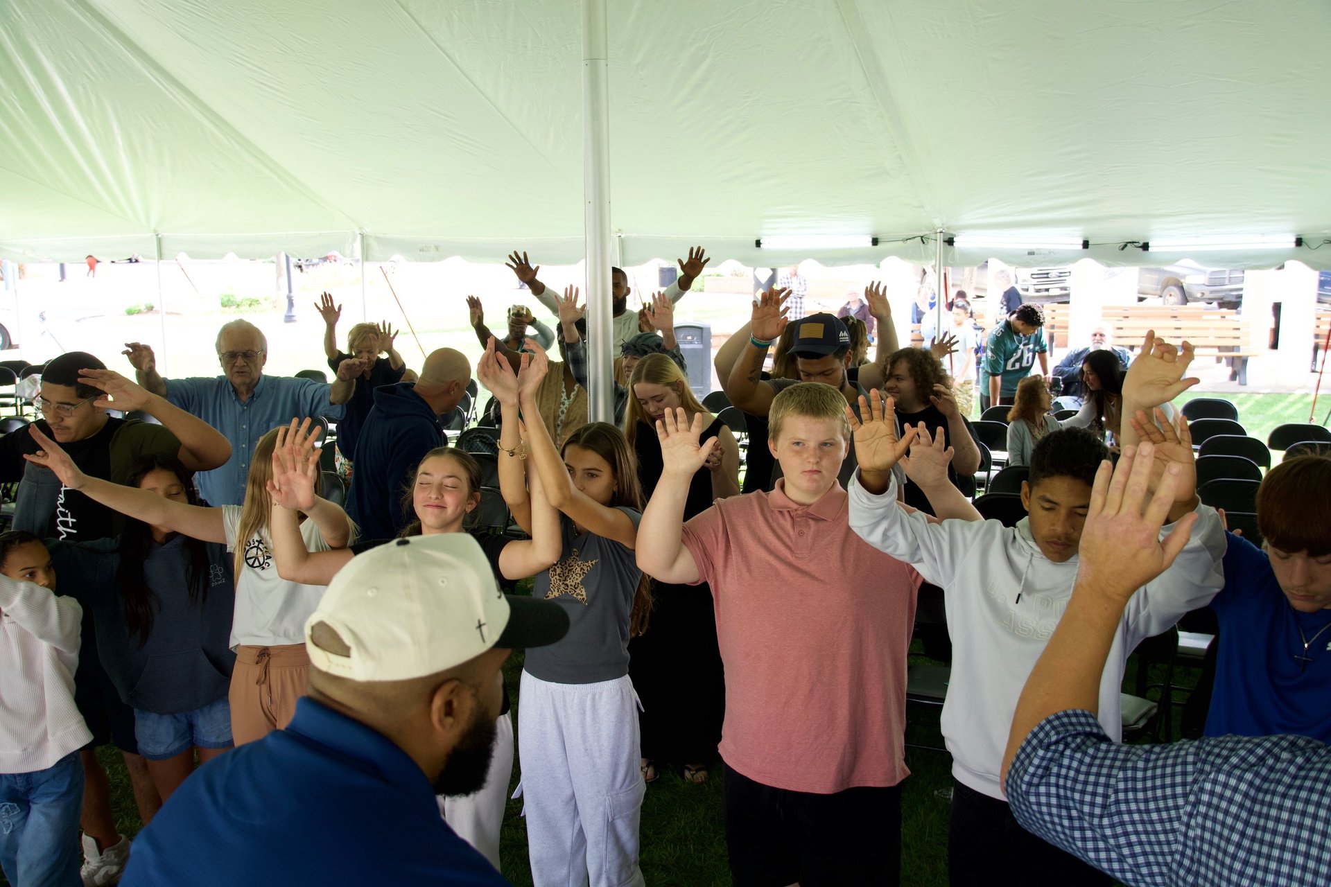 group of people sitting on white sand during daytime