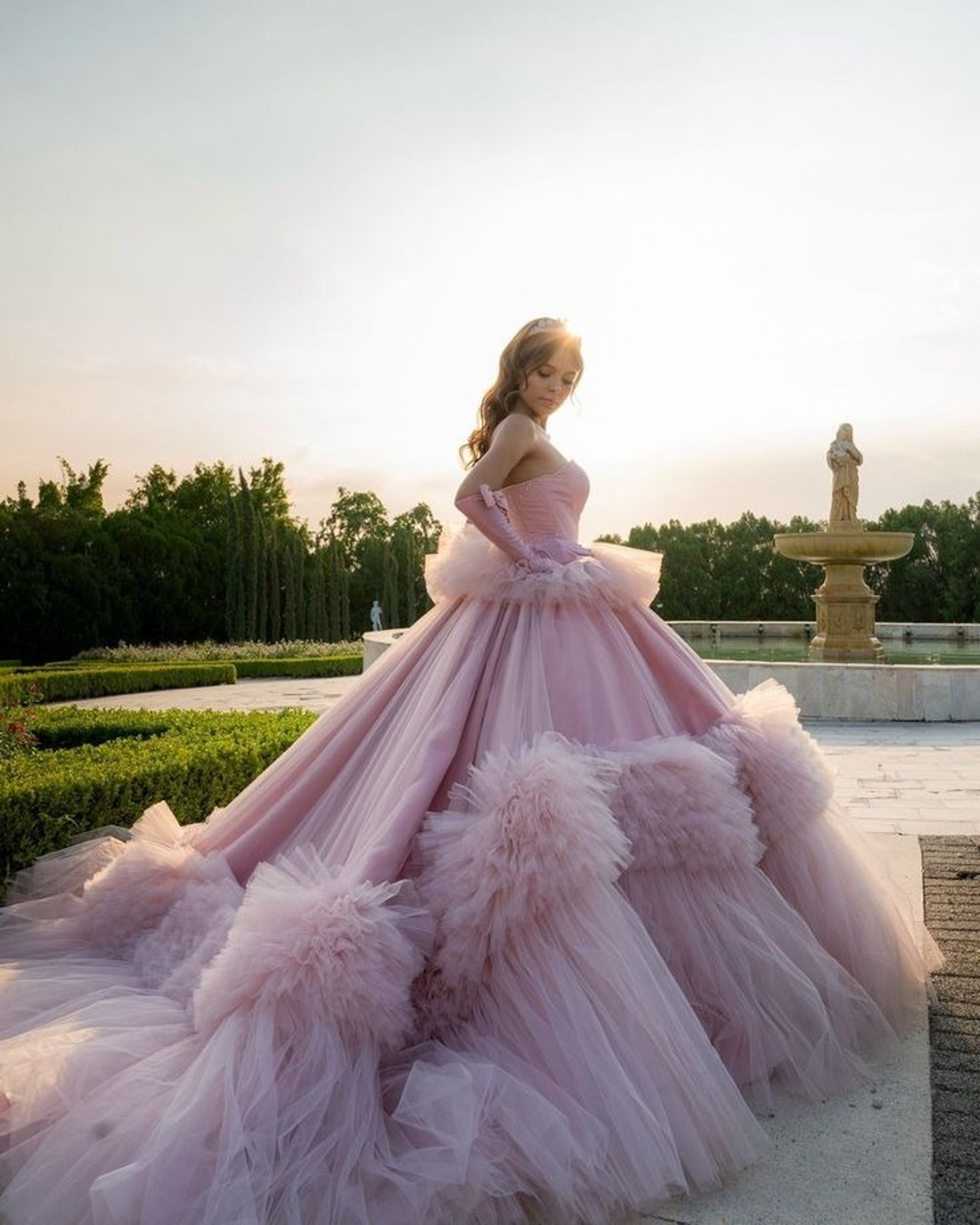 Woman in a light blue ballgown holding a bouquet