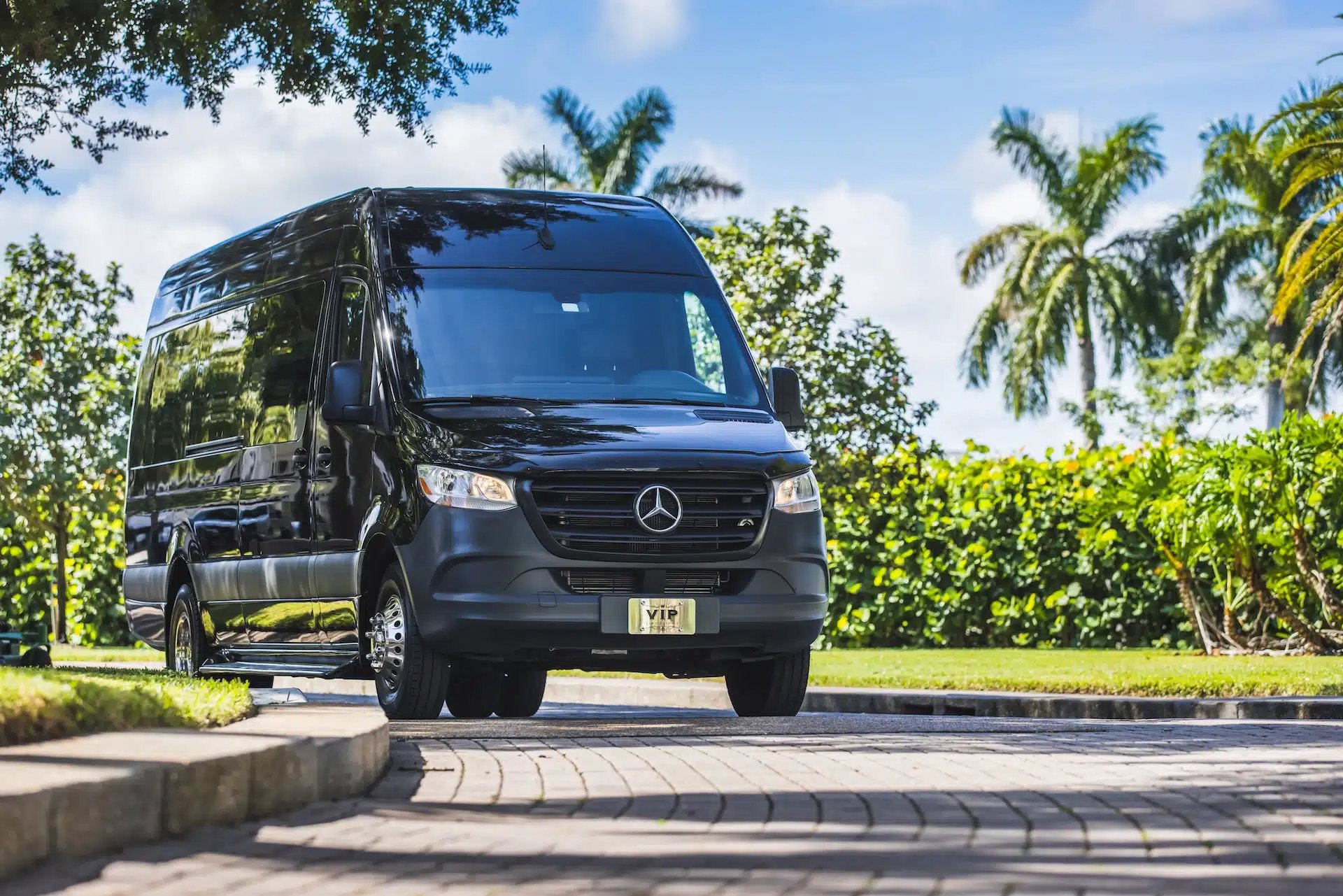 a black suv parked in front of a stone building