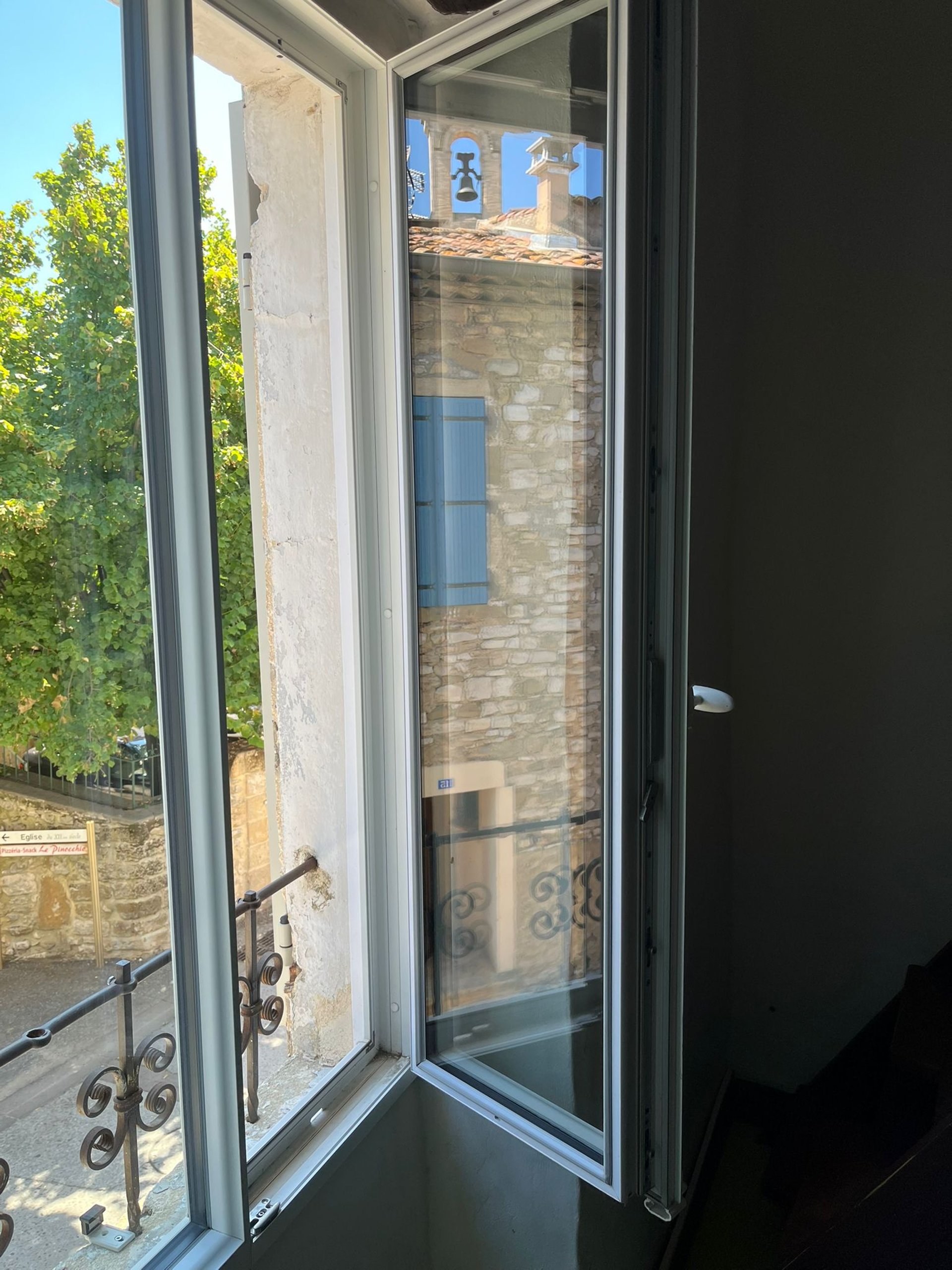 utility man standing in scissor platform cleaning glass window