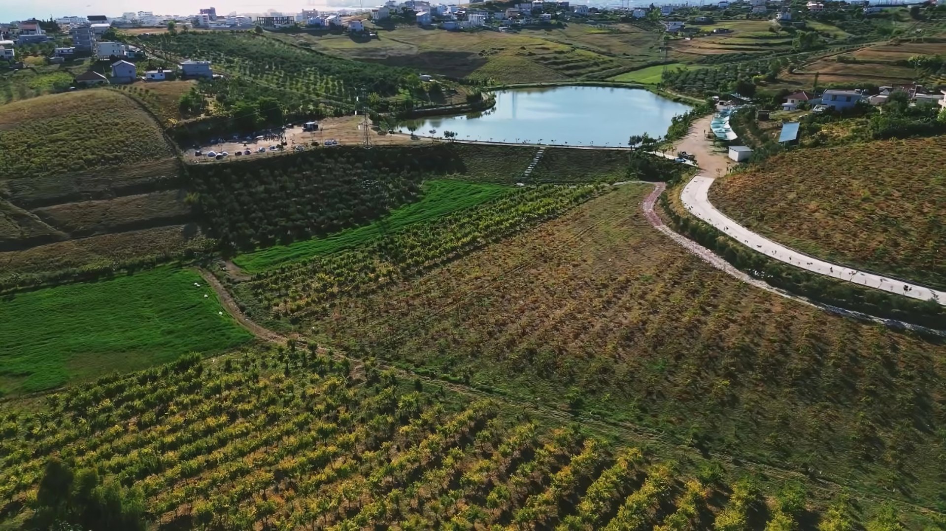 a couple of people walking across a snow covered field