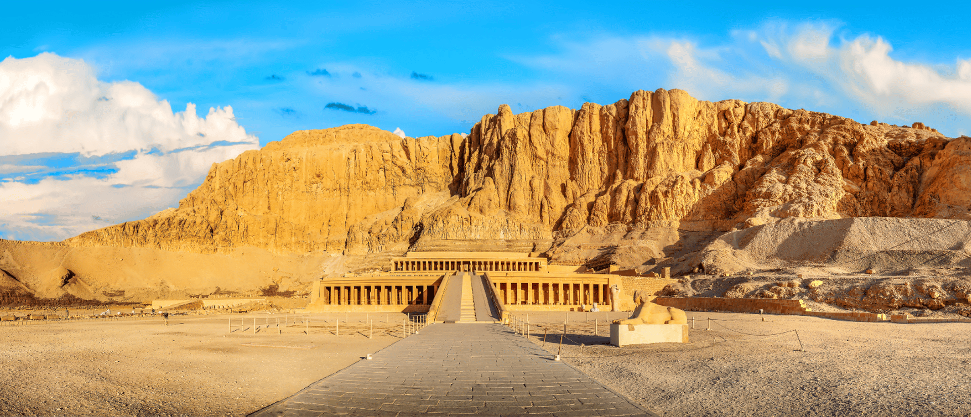 an abstract photo of a curved building with a blue sky in the background