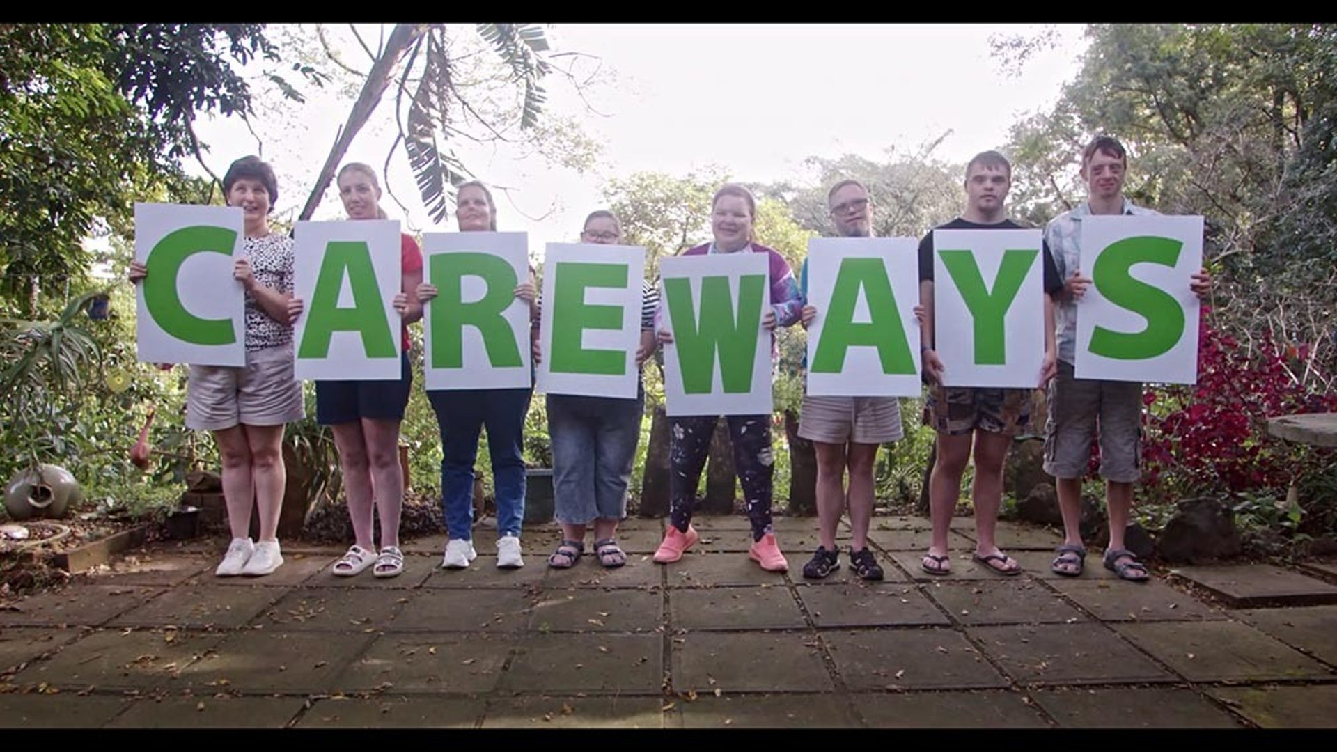 people holding shoulders sitting on wall