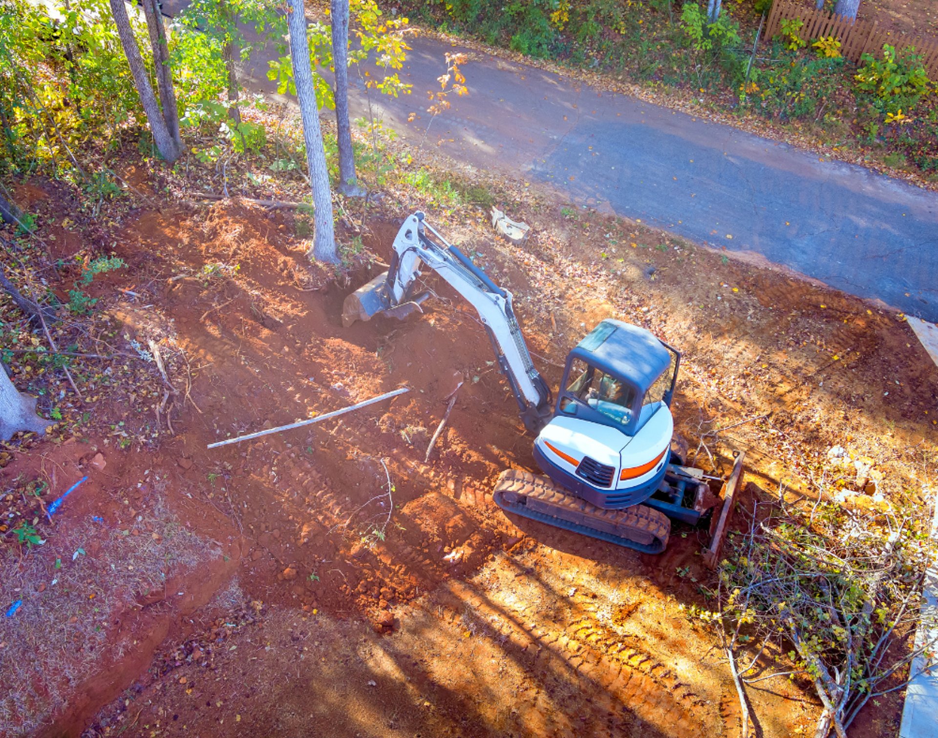 excavator digging into hill