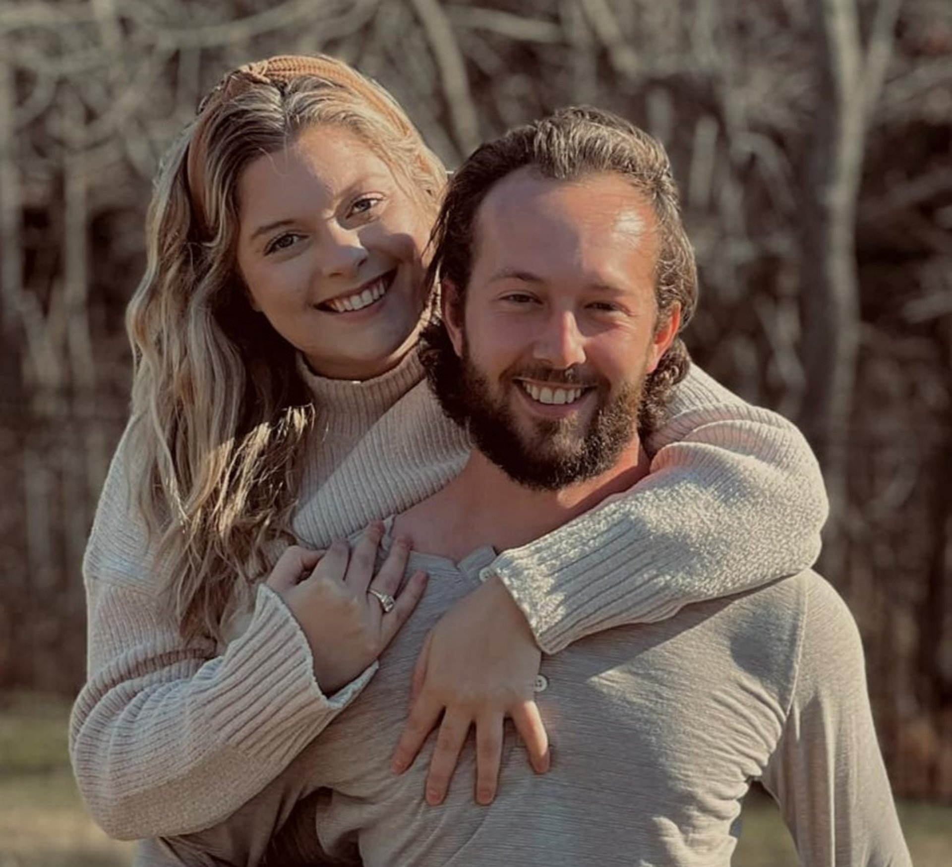 gray asphalt road between brown trees during daytime