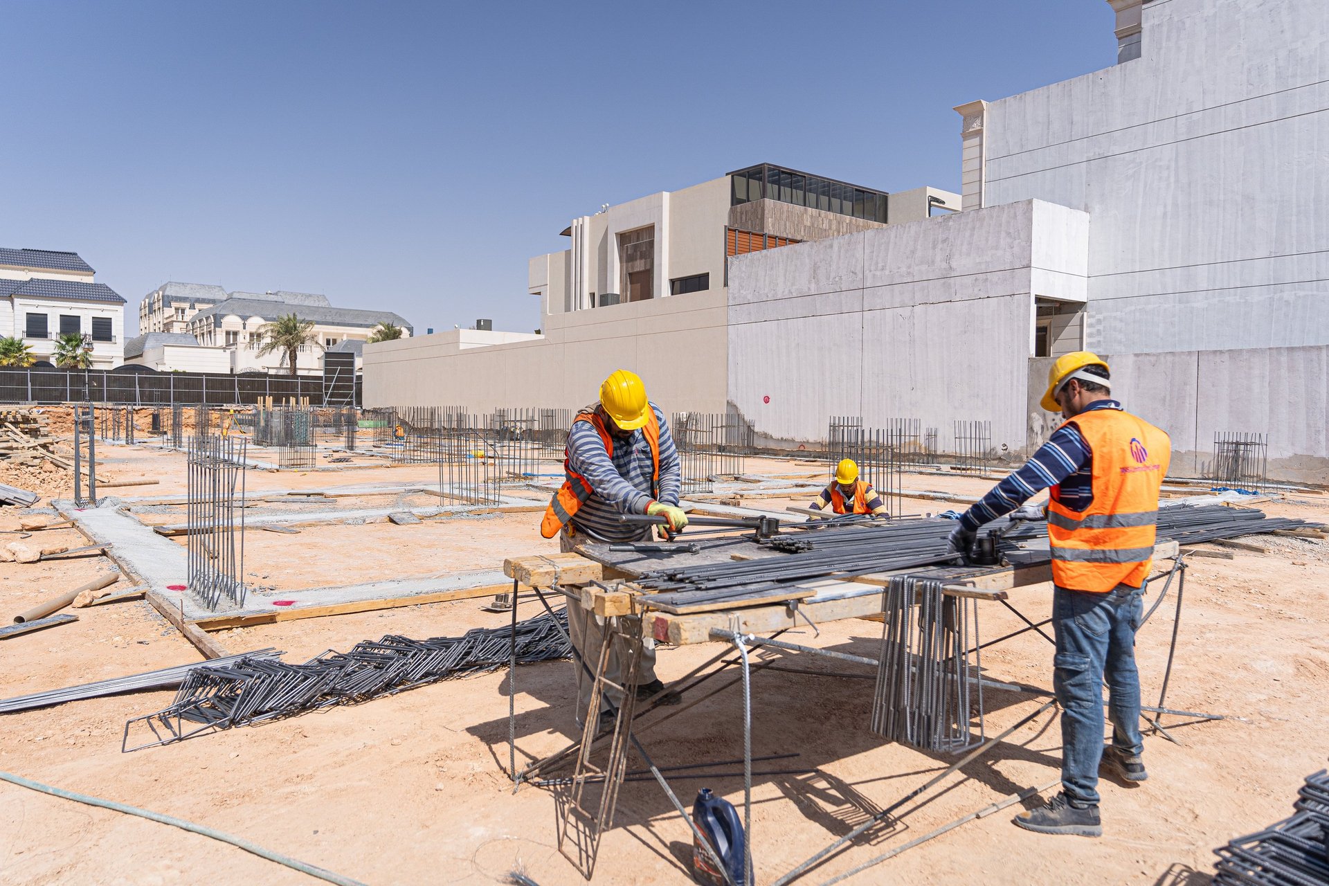 seven construction workers standing on white field