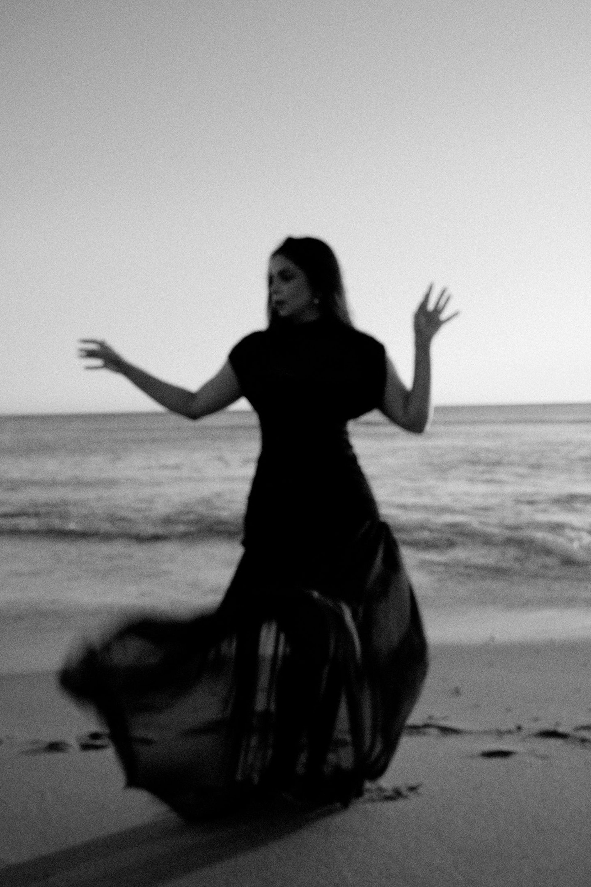 an abstract photo of a curved building with a blue sky in the background