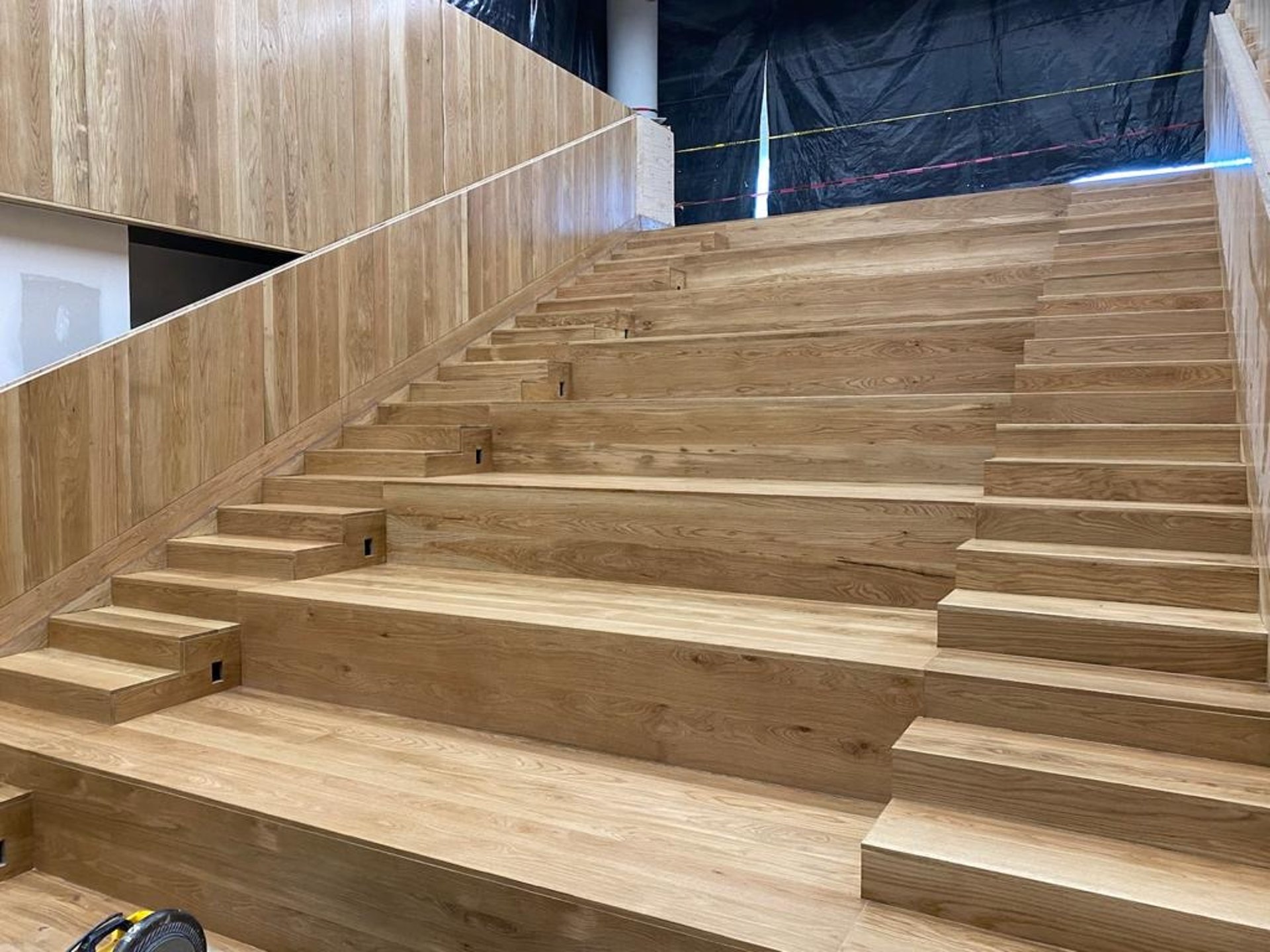an abstract photo of a curved building with a blue sky in the background