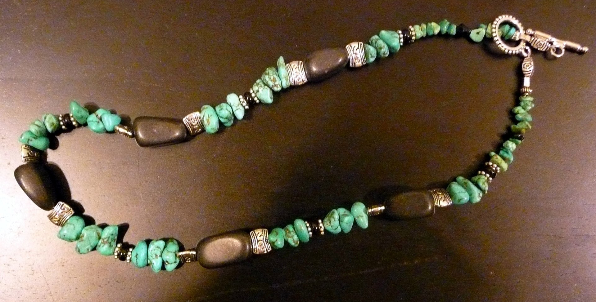 a close up of a beaded necklace on a table