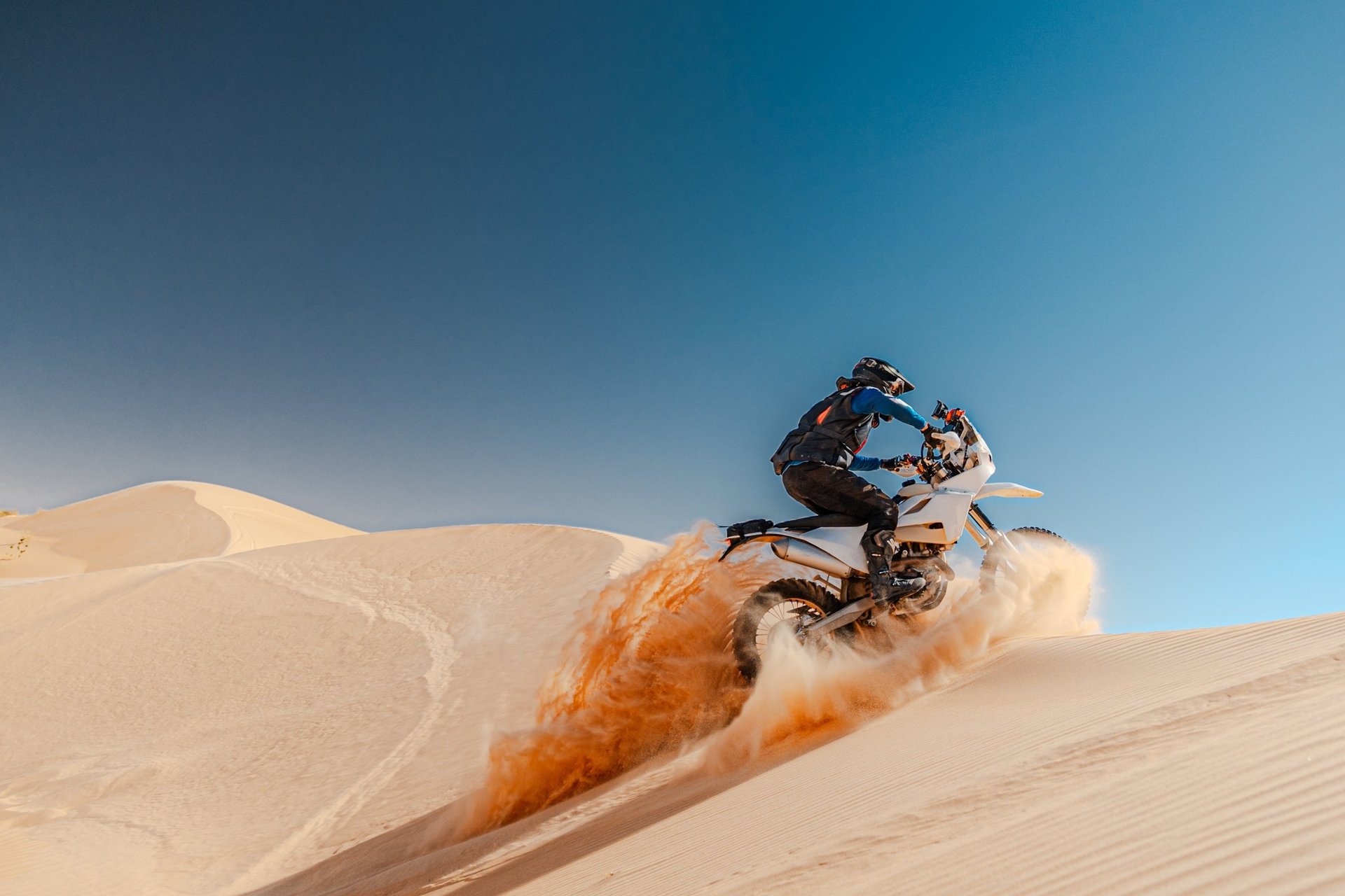 person gliding in snow during day time