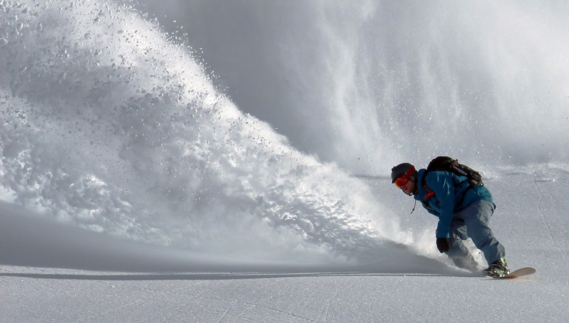 person gliding in snow during day time