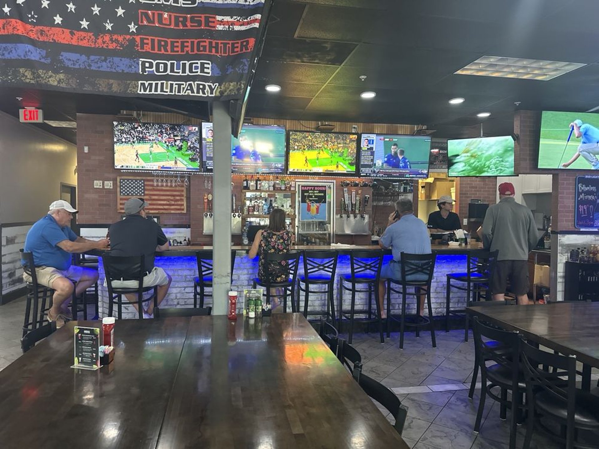 a bar with a lot of bottles on the ceiling