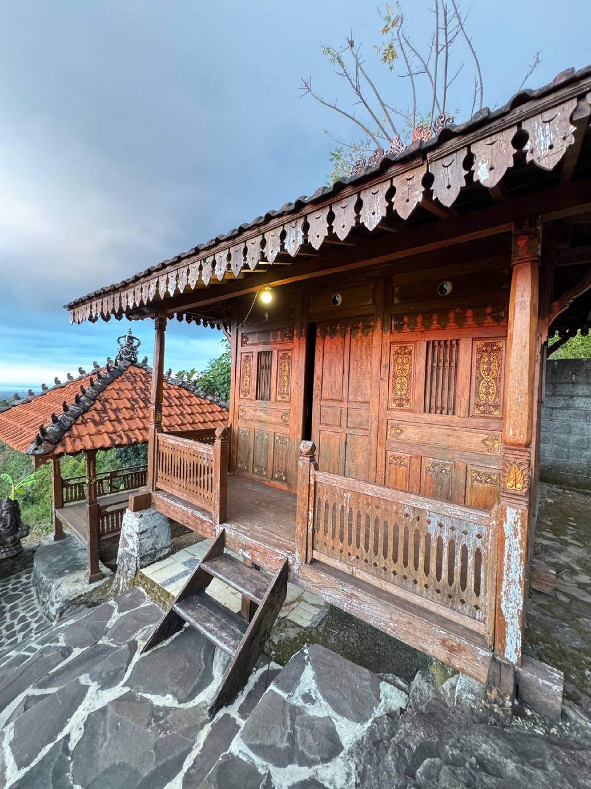 Joglo construction workshop where artisans prepare antique teak wood components for global export projects