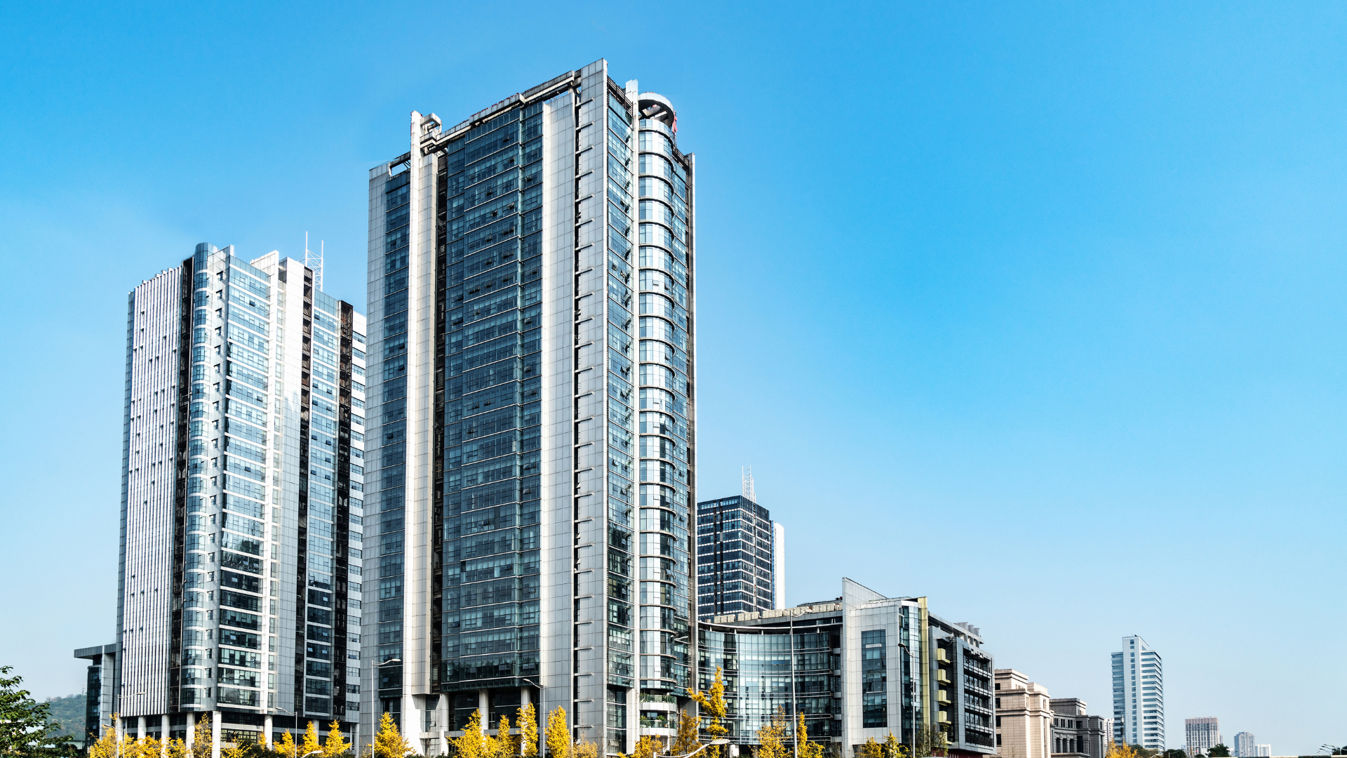 city skyline across body of water during night time