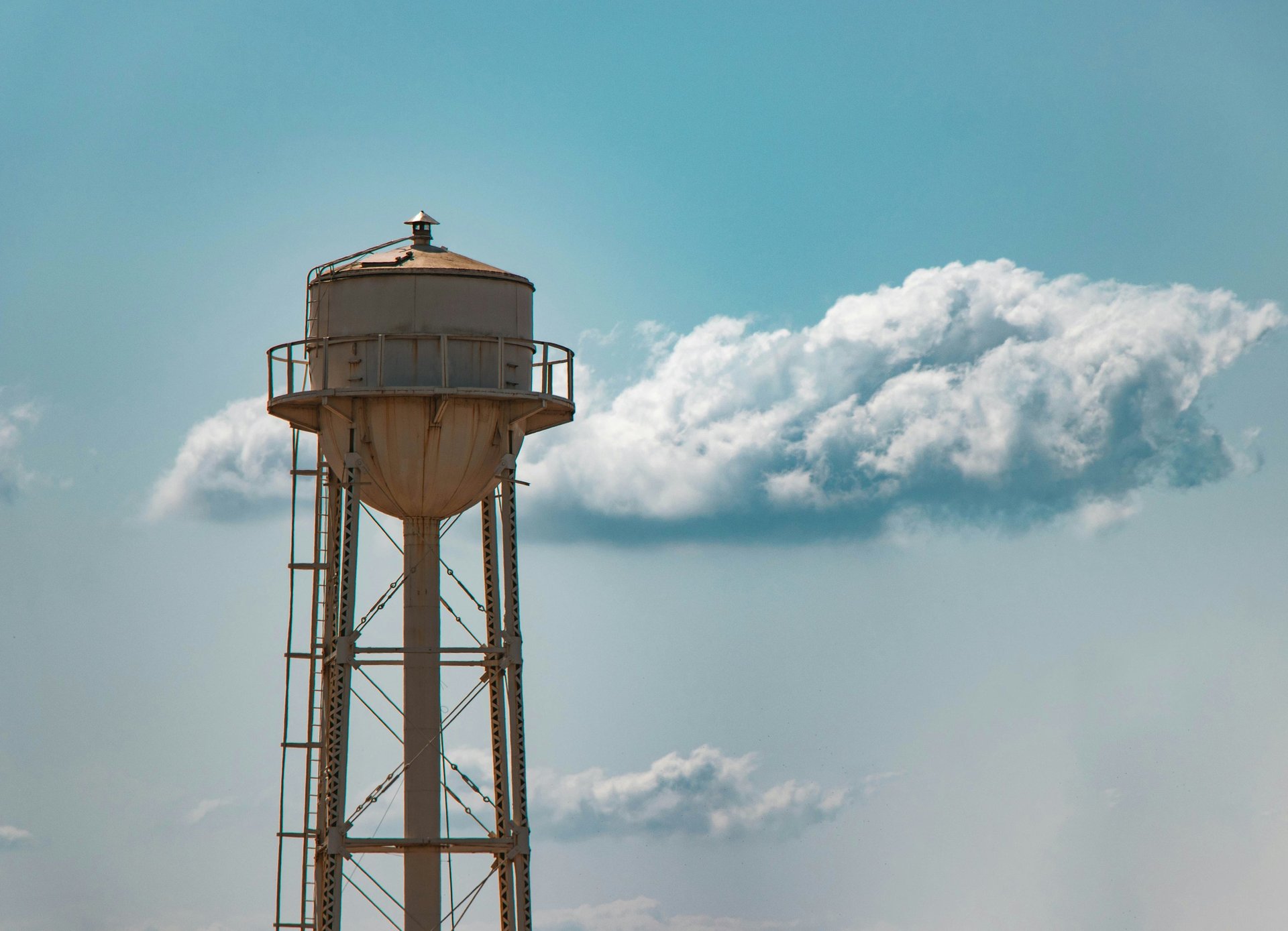 woman wearing yellow long-sleeved dress under white clouds and blue sky during daytime
