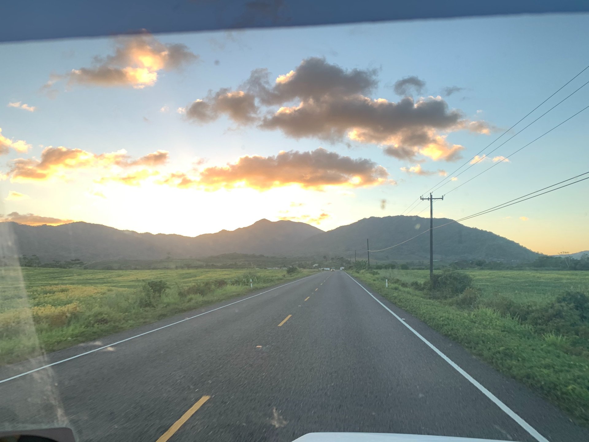 woman wearing yellow long-sleeved dress under white clouds and blue sky during daytime
