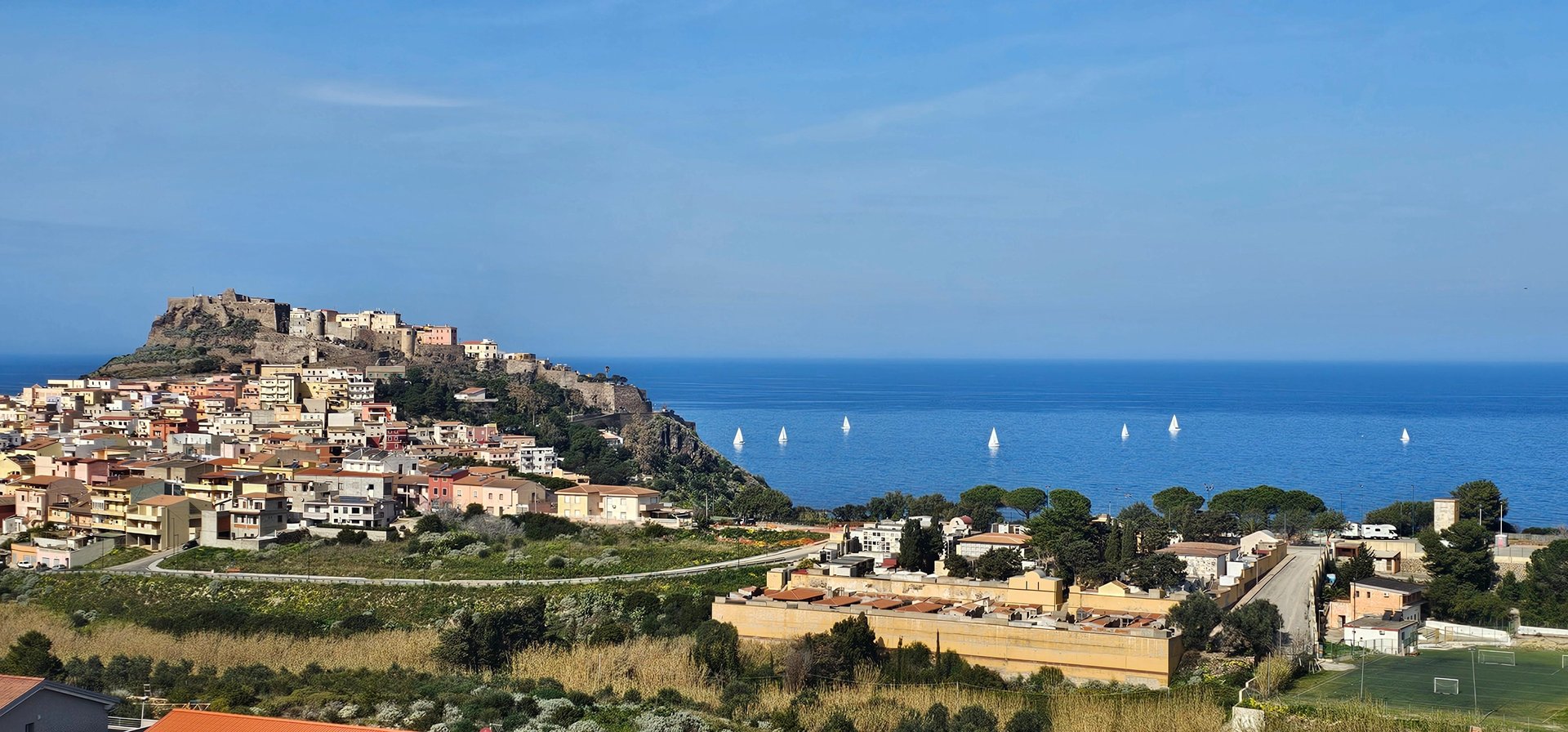 an abstract photo of a curved building with a blue sky in the background