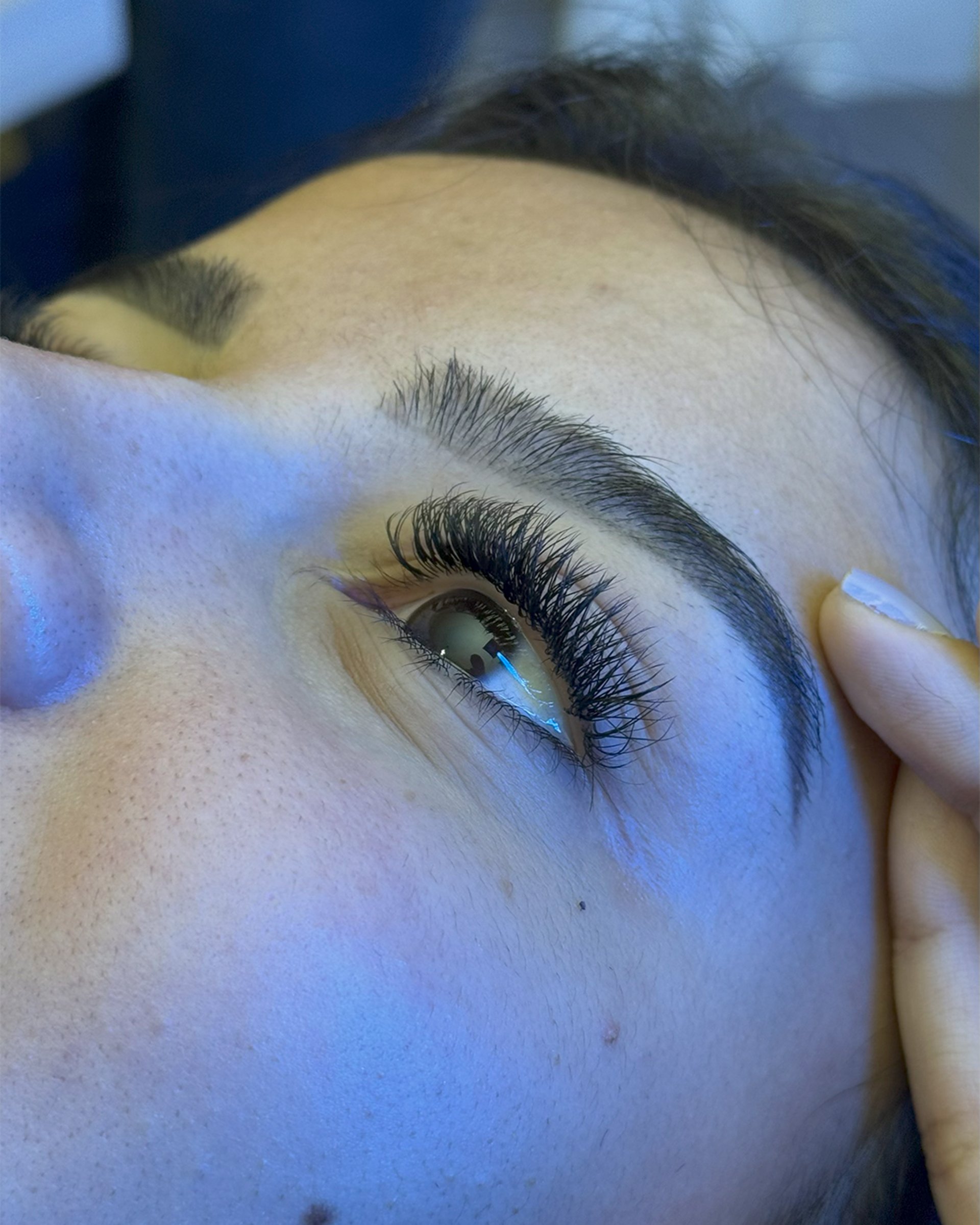 A close up of a person cutting a persons eye