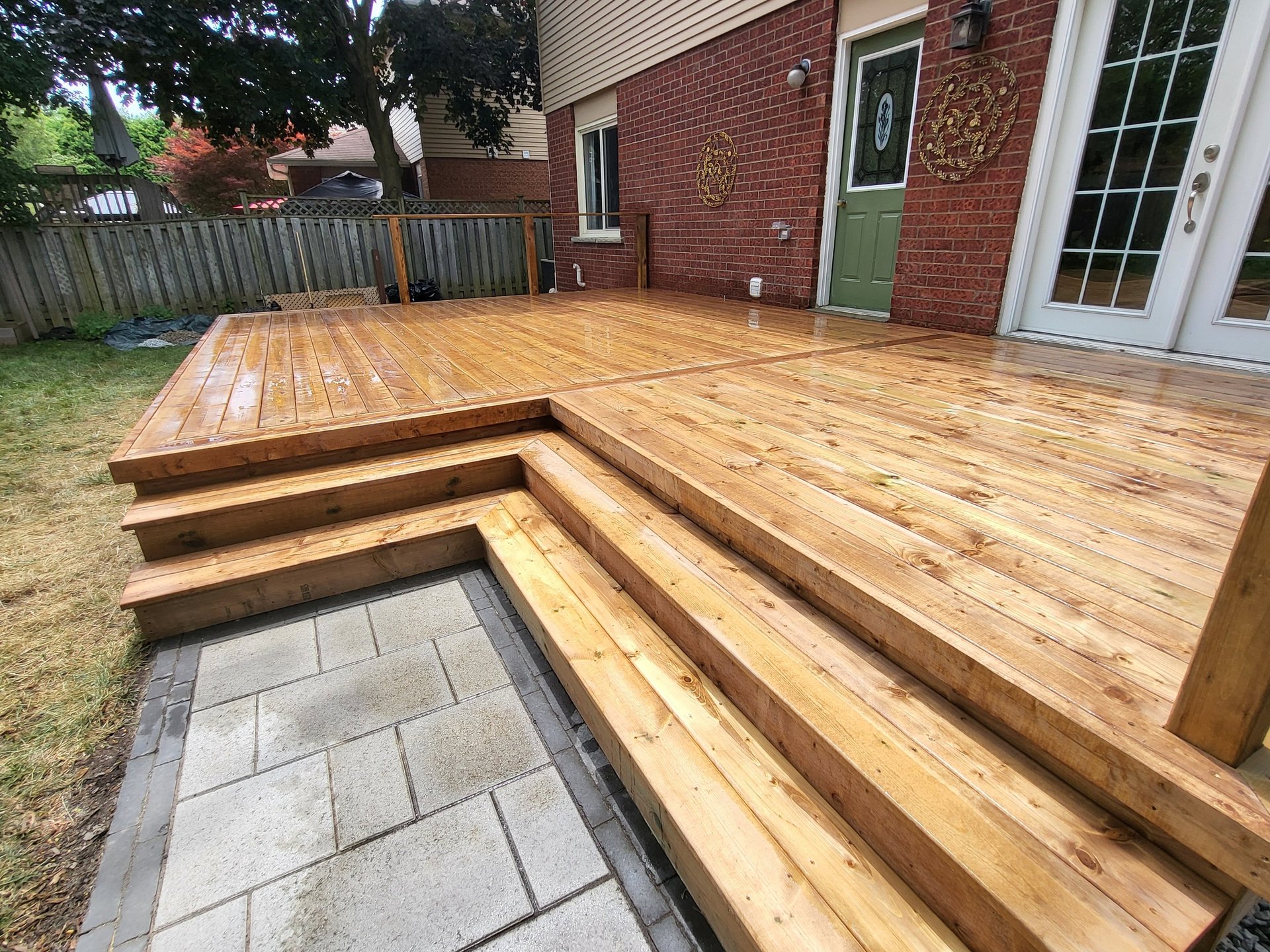a wooden deck with a table and chairs on it