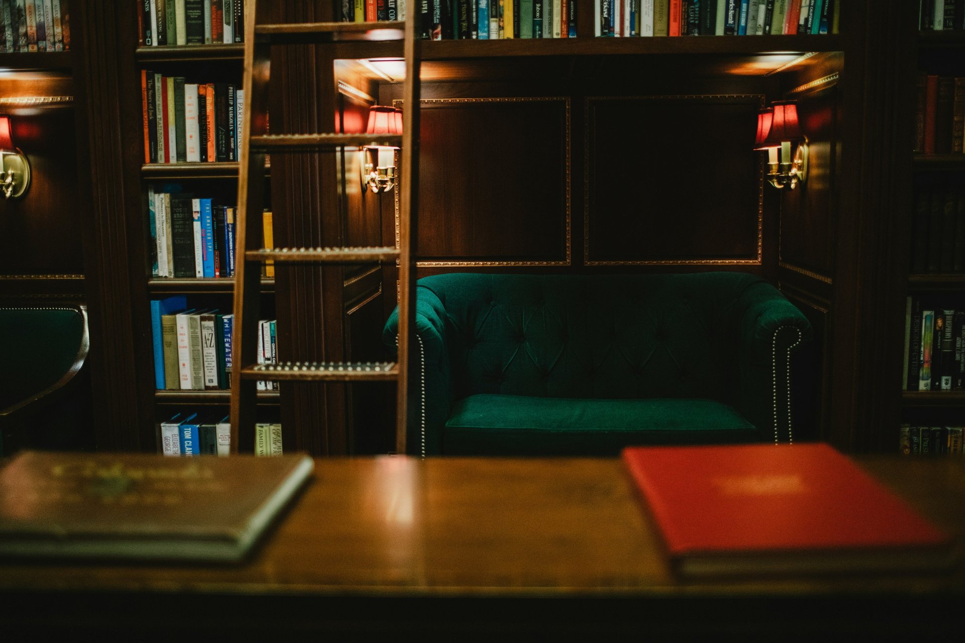 A stack of books sitting on top of a wooden table