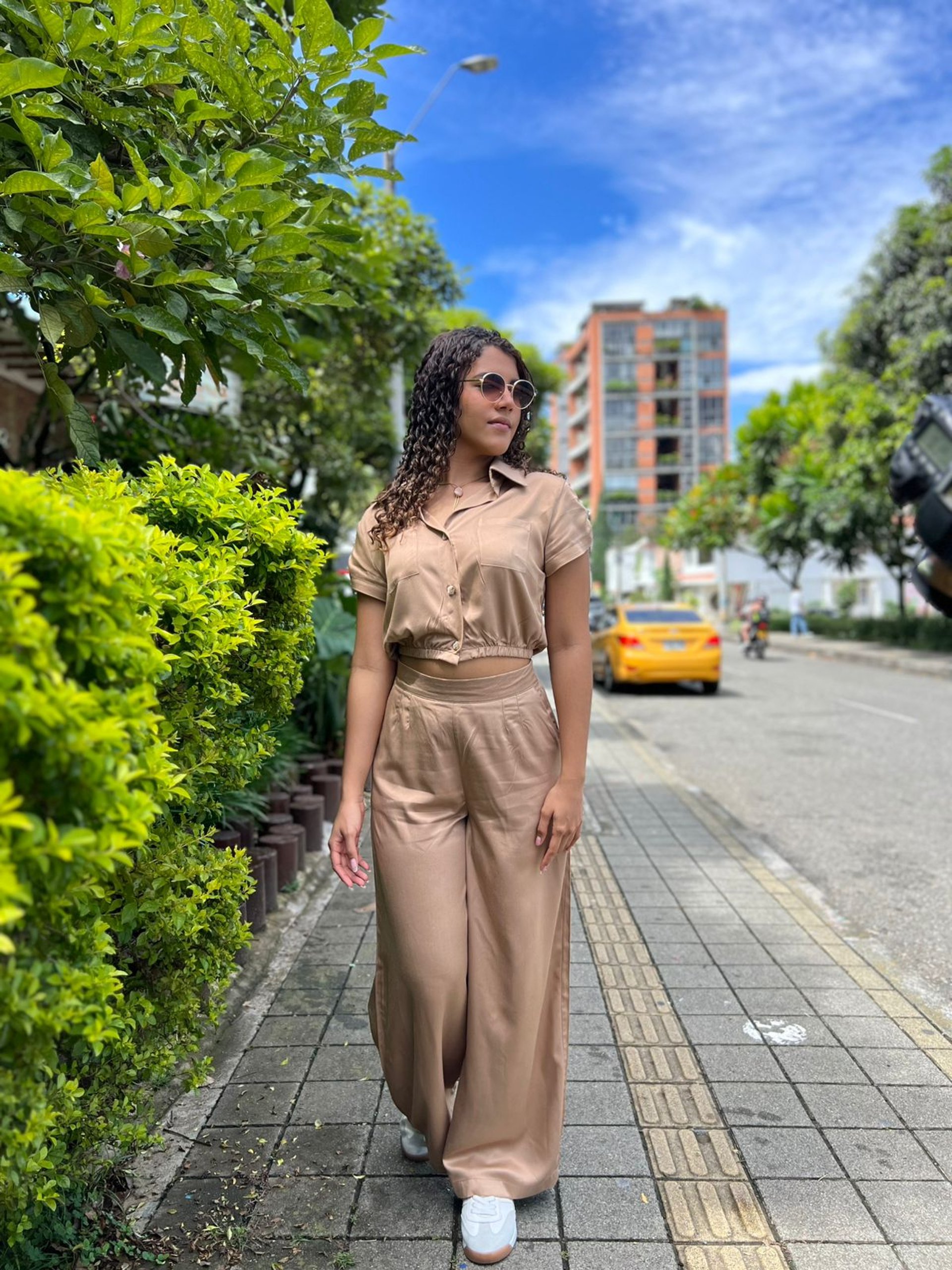 woman wearing yellow long-sleeved dress under white clouds and blue sky during daytime