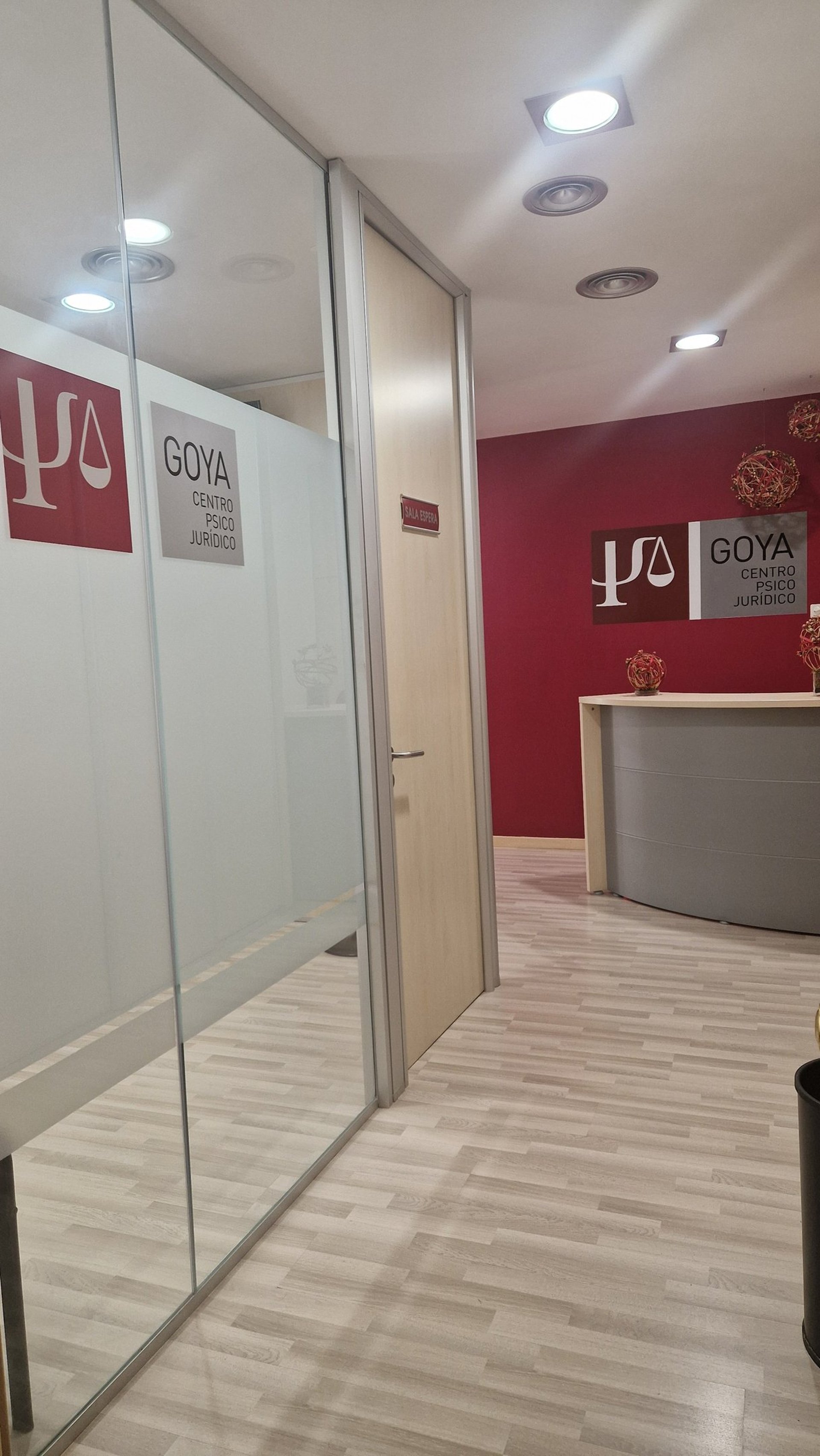 woman in blue tank top standing beside white wall