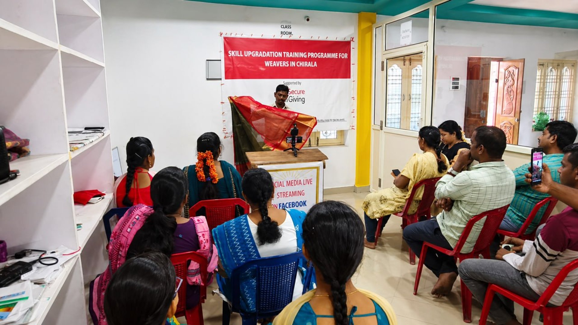 a group of people in a room with a projector screen