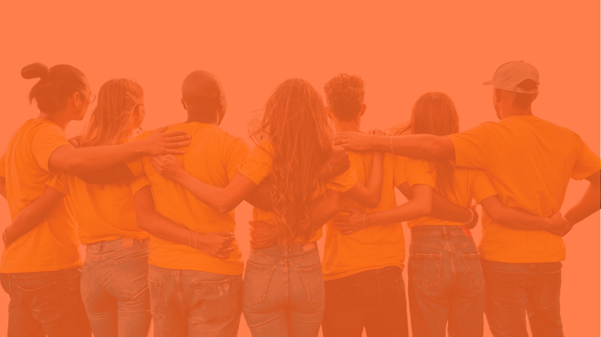 a woman standing behind a pile of ripe bananas