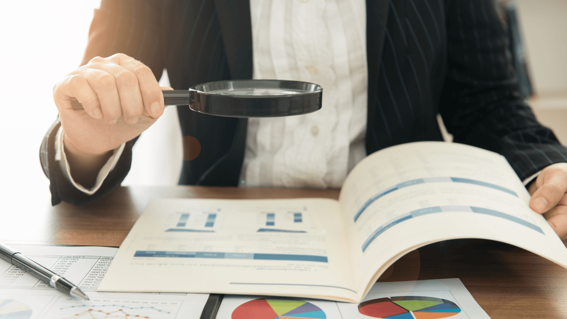 magnifying glass near gray laptop computer