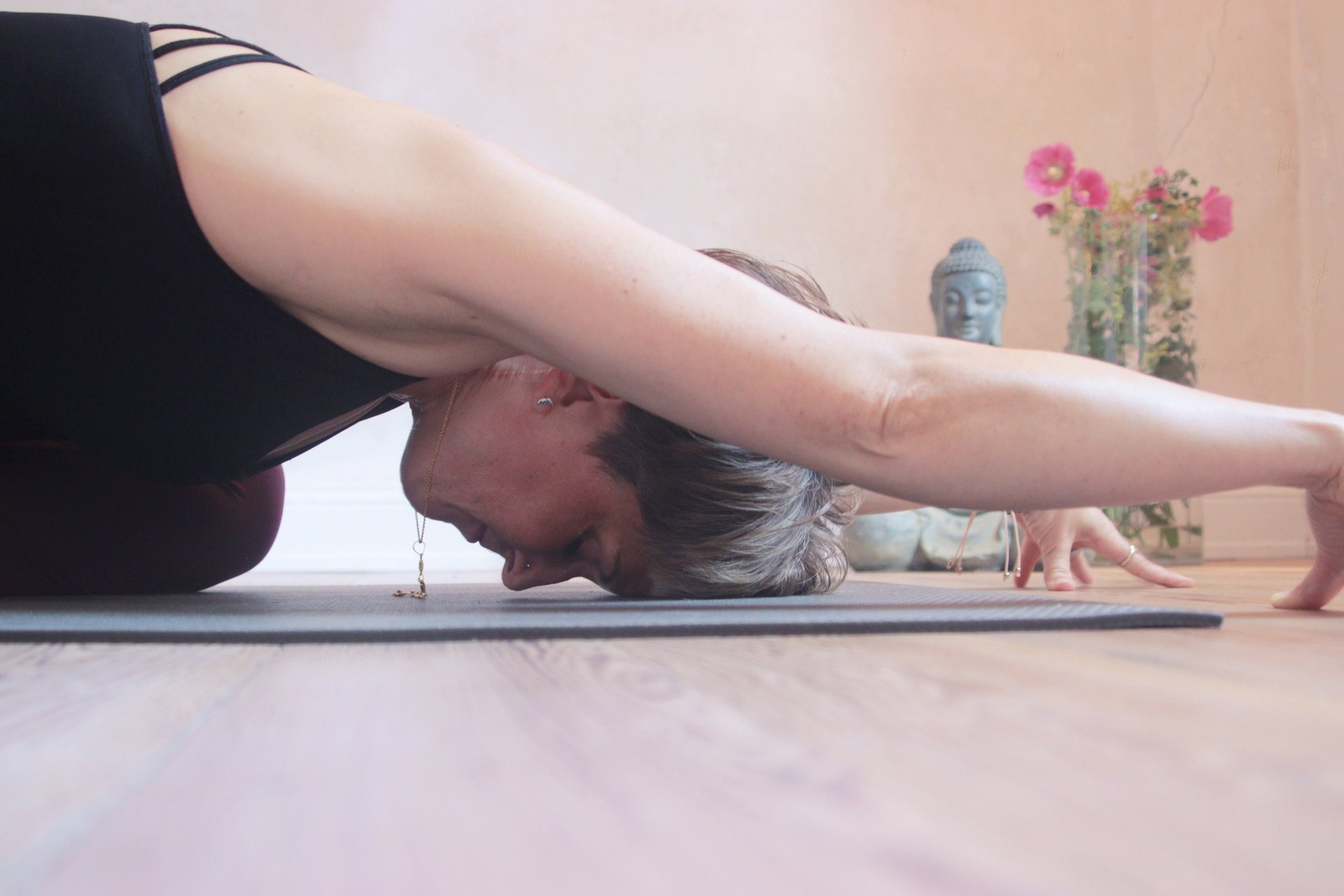 A woman standing on a yoga mat with her feet on the mat