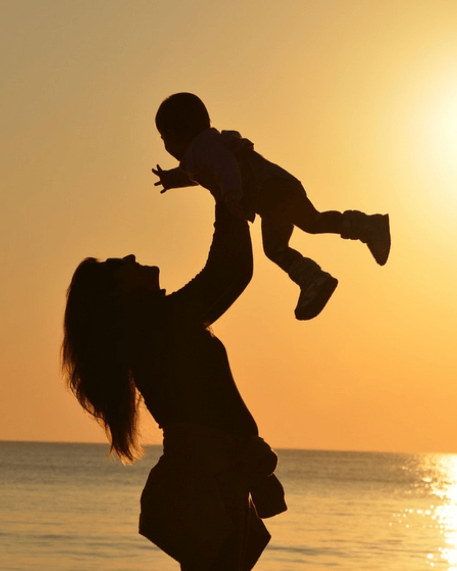 a woman holding a baby in her arms