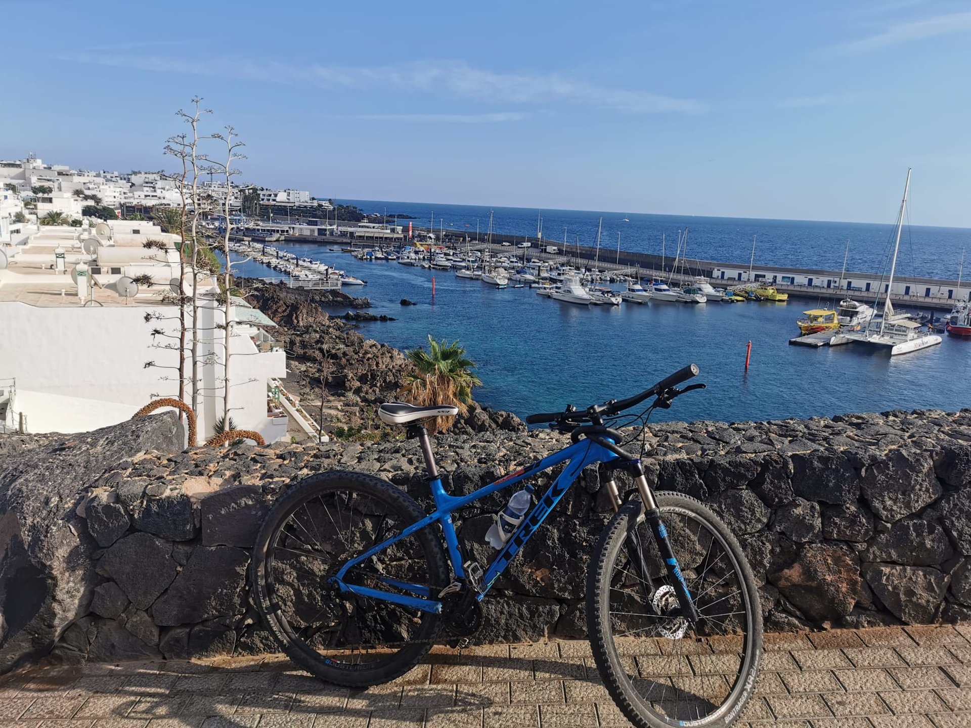 a person laying on the beach next to a bike