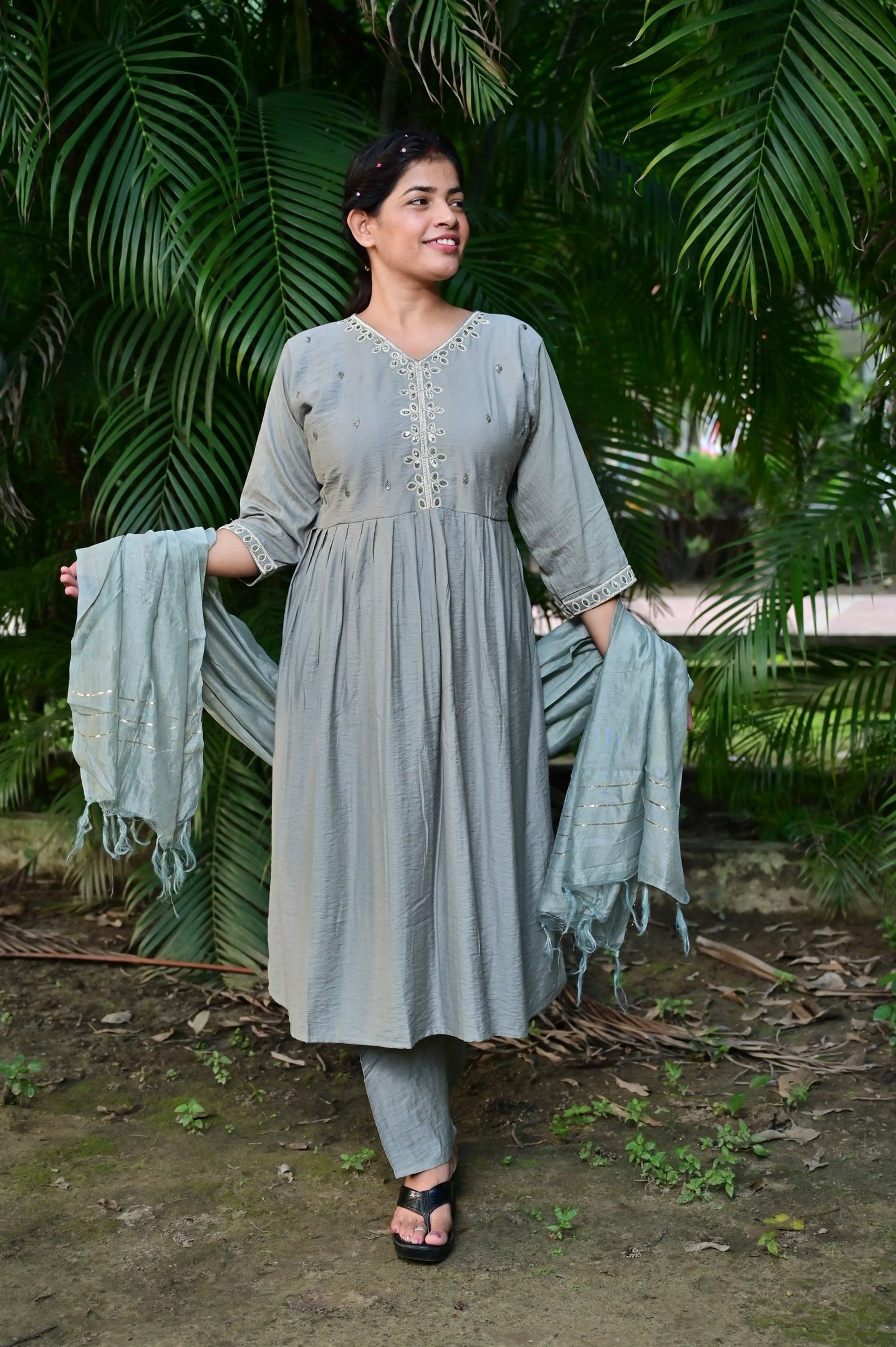 front-view of suit wearing women with trees in background