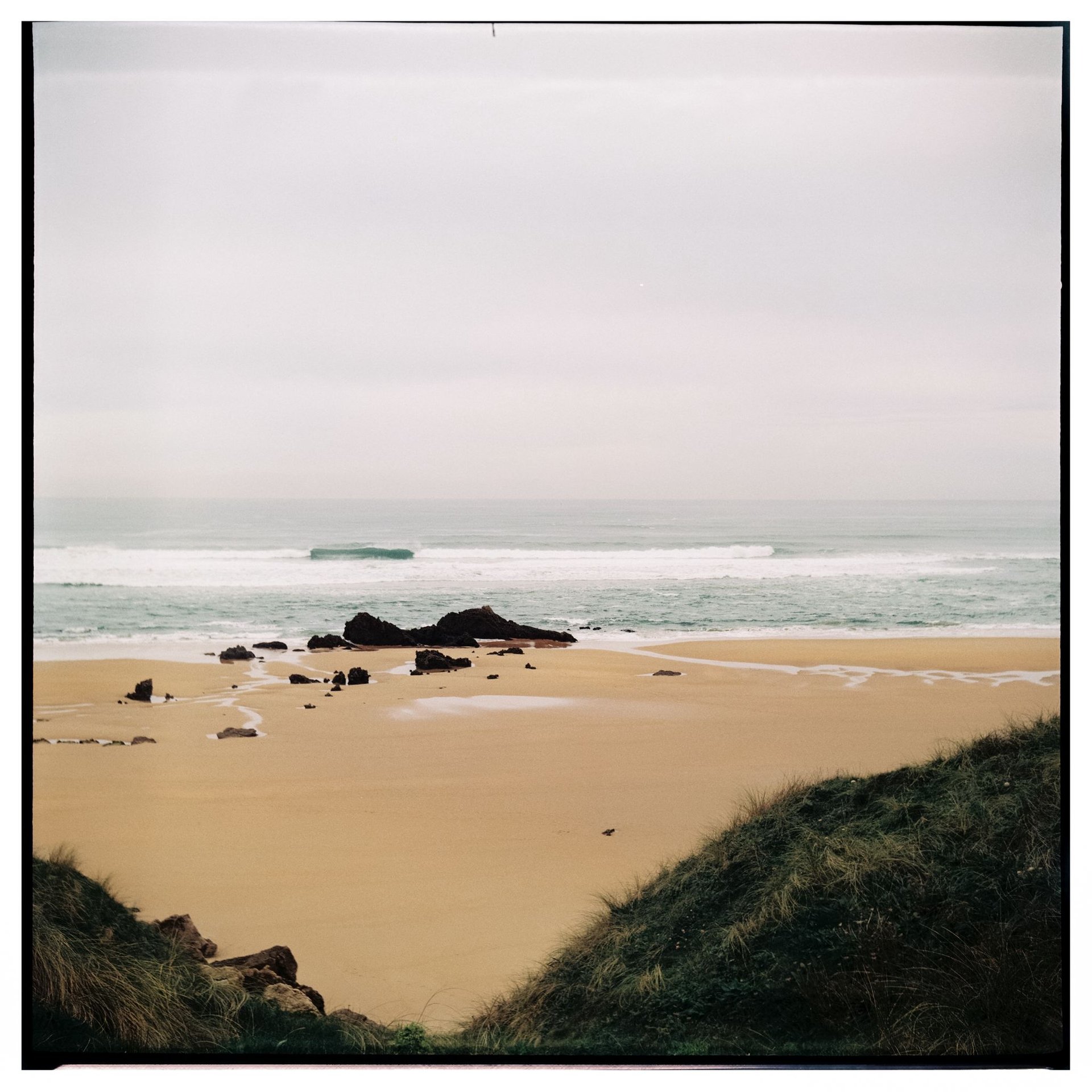 a sandy beach with footprints in the sand