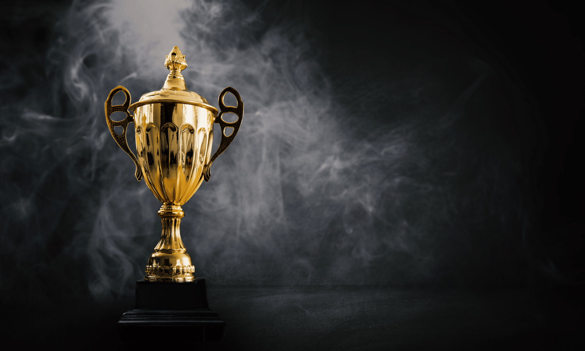 a golden statue of a man standing next to a black wall