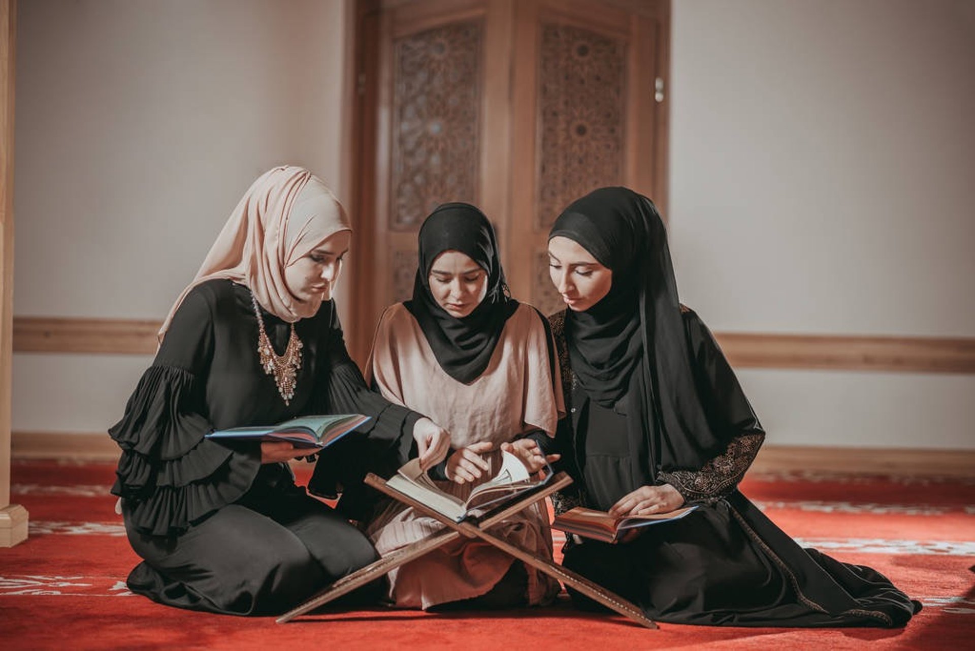 a woman in a hijab reading a book