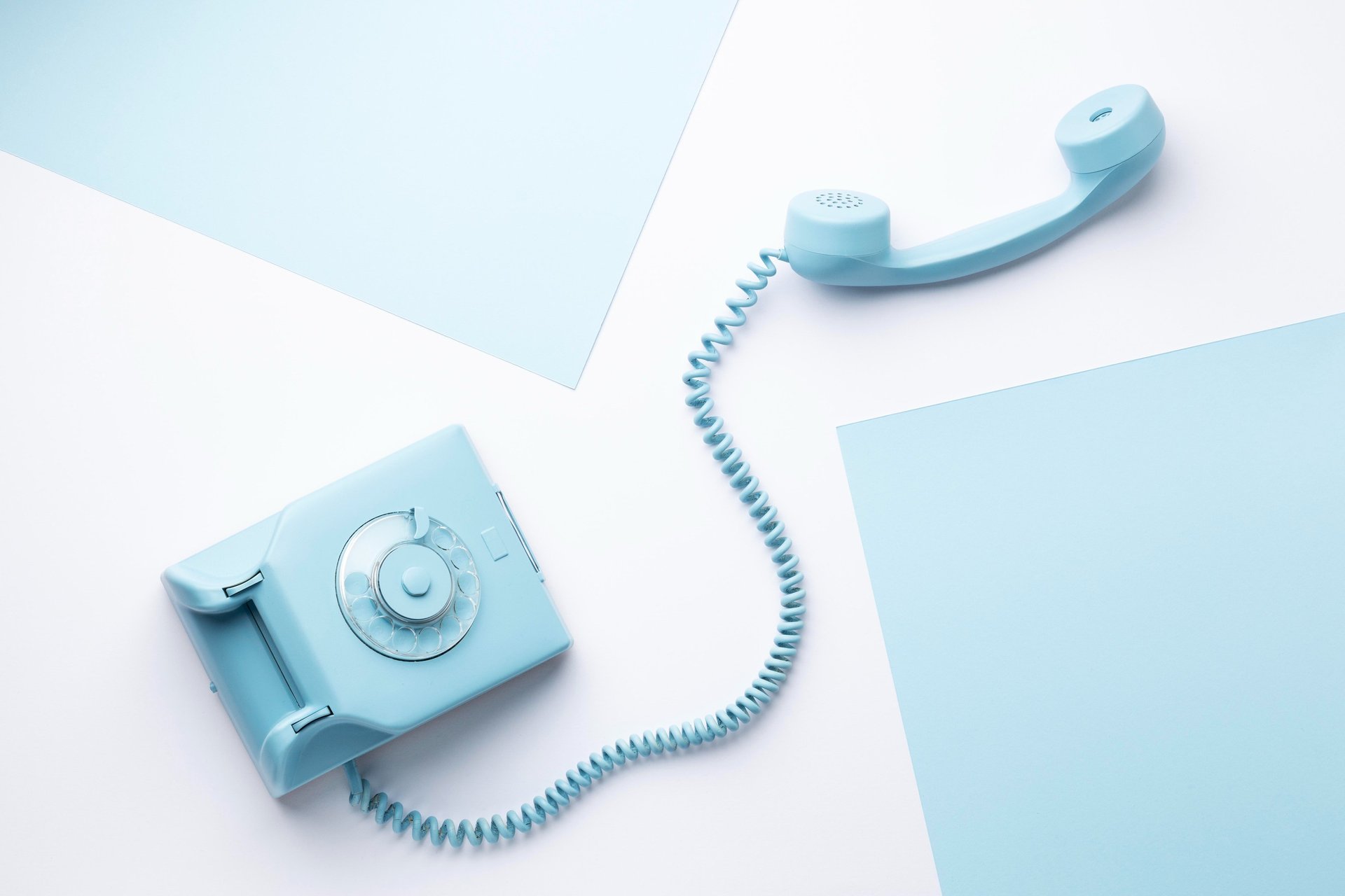 white rotary phone on pink table