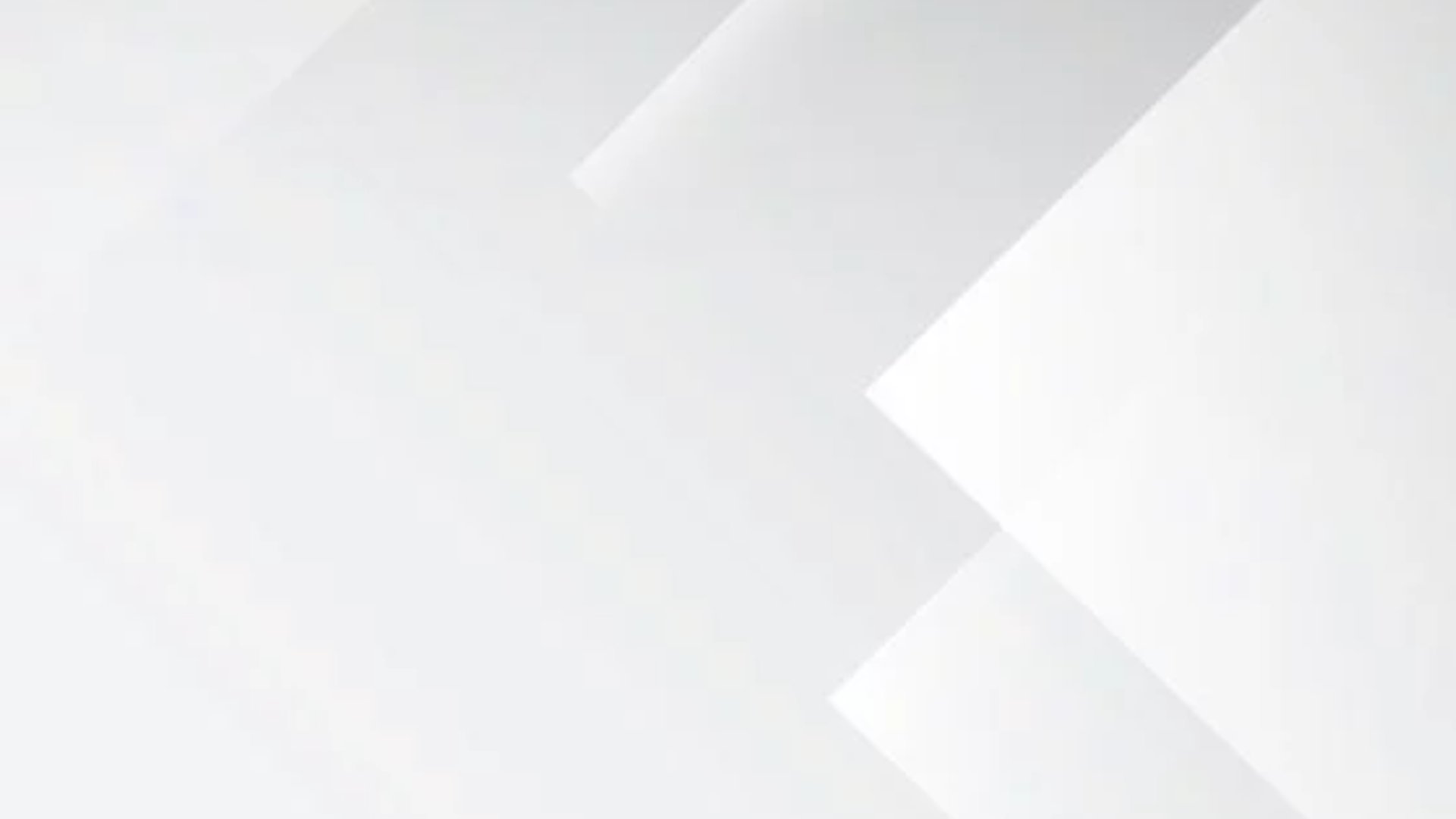 an abstract photo of a curved building with a blue sky in the background