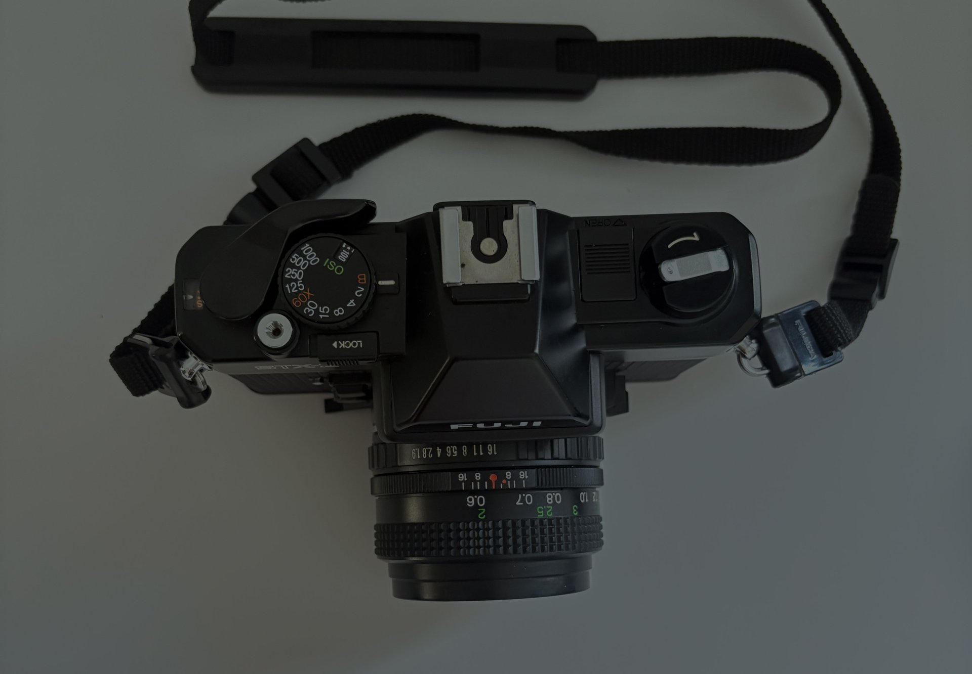 an abstract photo of a curved building with a blue sky in the background