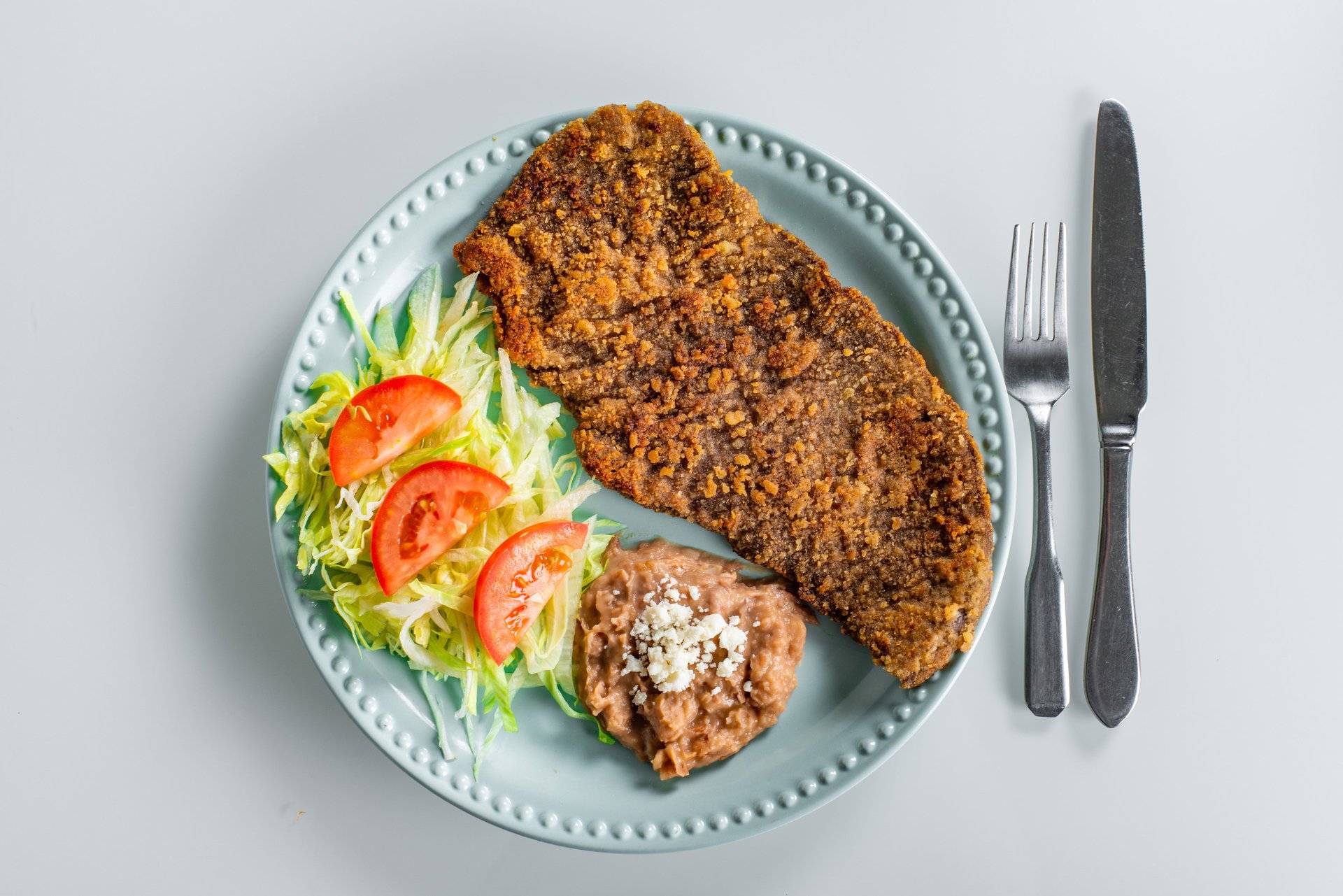 an abstract photo of a curved building with a blue sky in the background