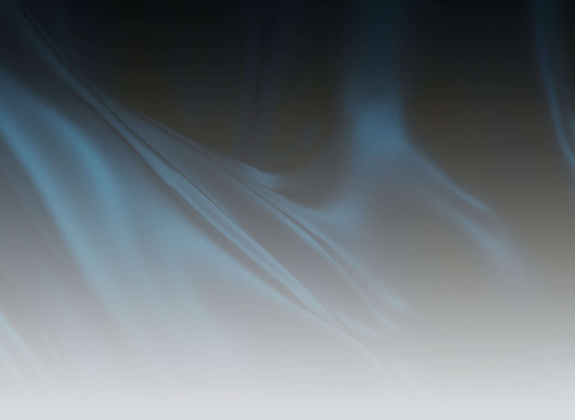 Flowing blue fabric against a dark background.