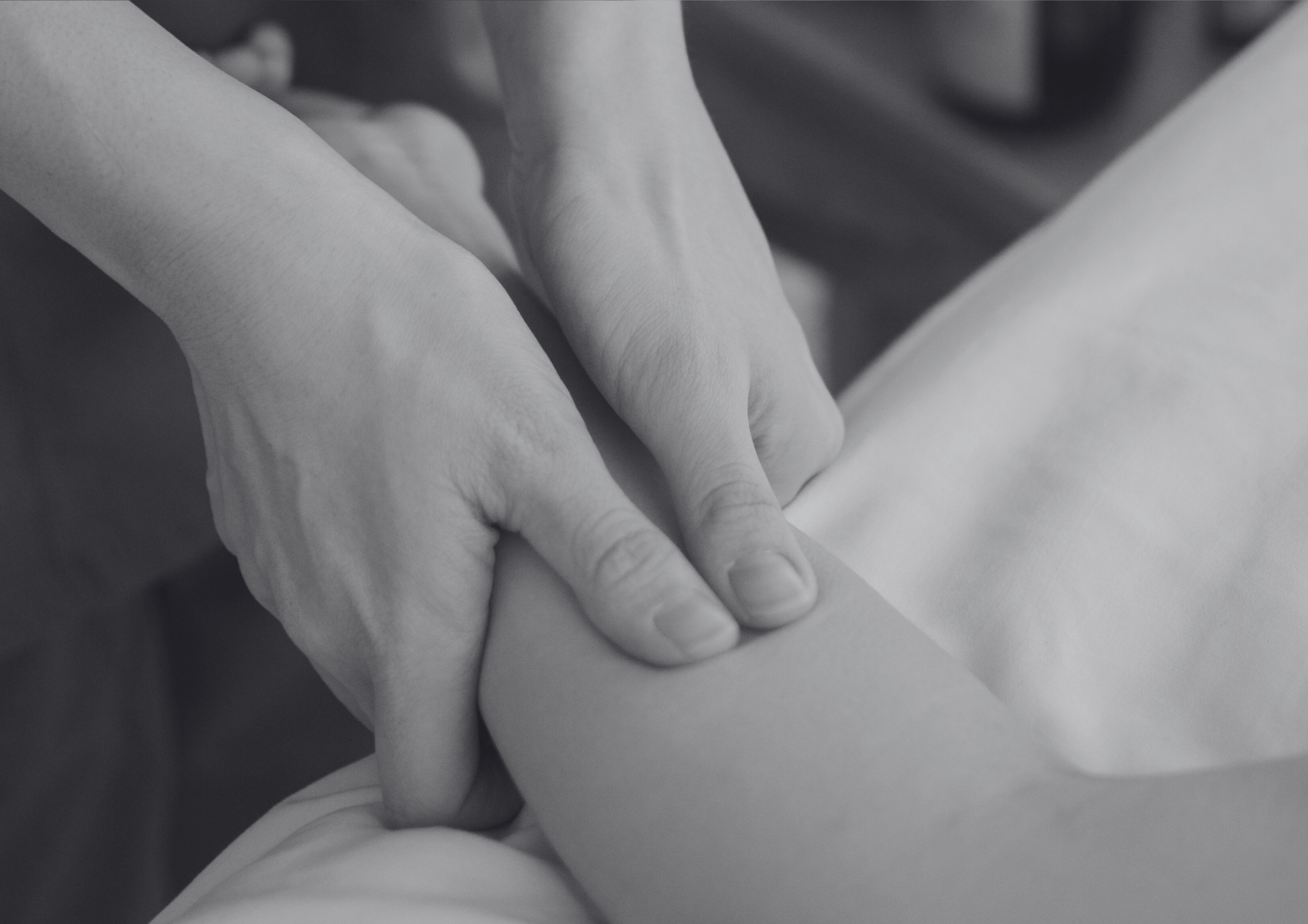 a person laying on a bed with their hands on their back