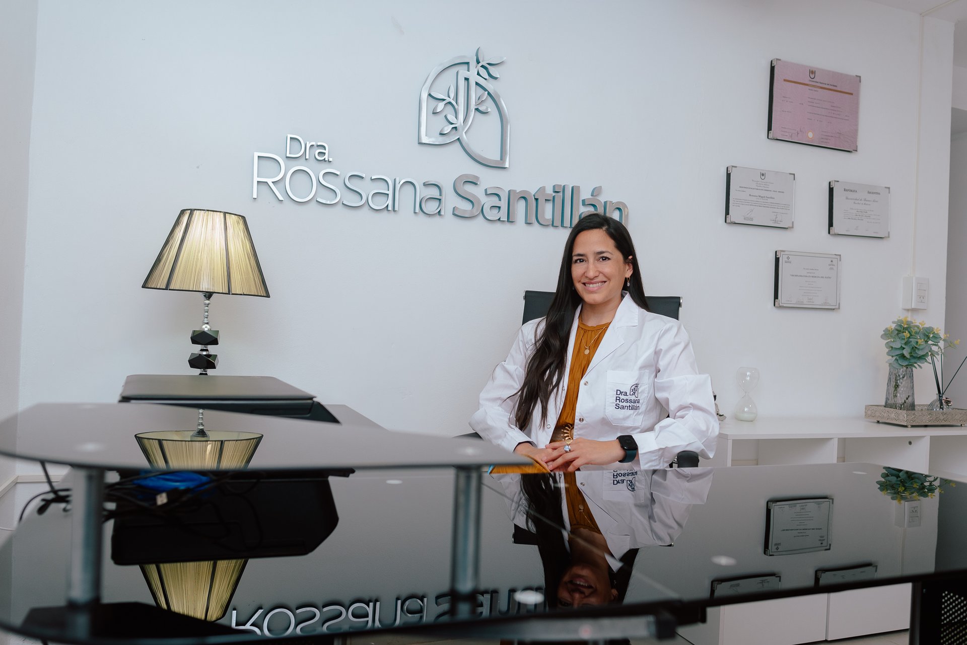 a woman in a white shirt holding a stethoscope