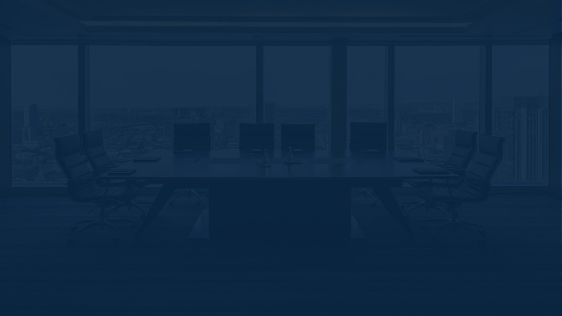 A smiling man wearing glasses in an office setting.