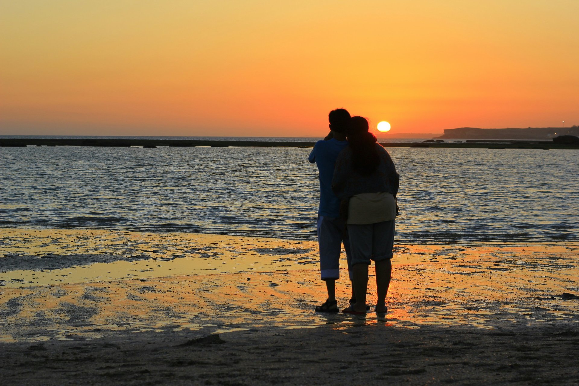 silhouette group of people under sunset