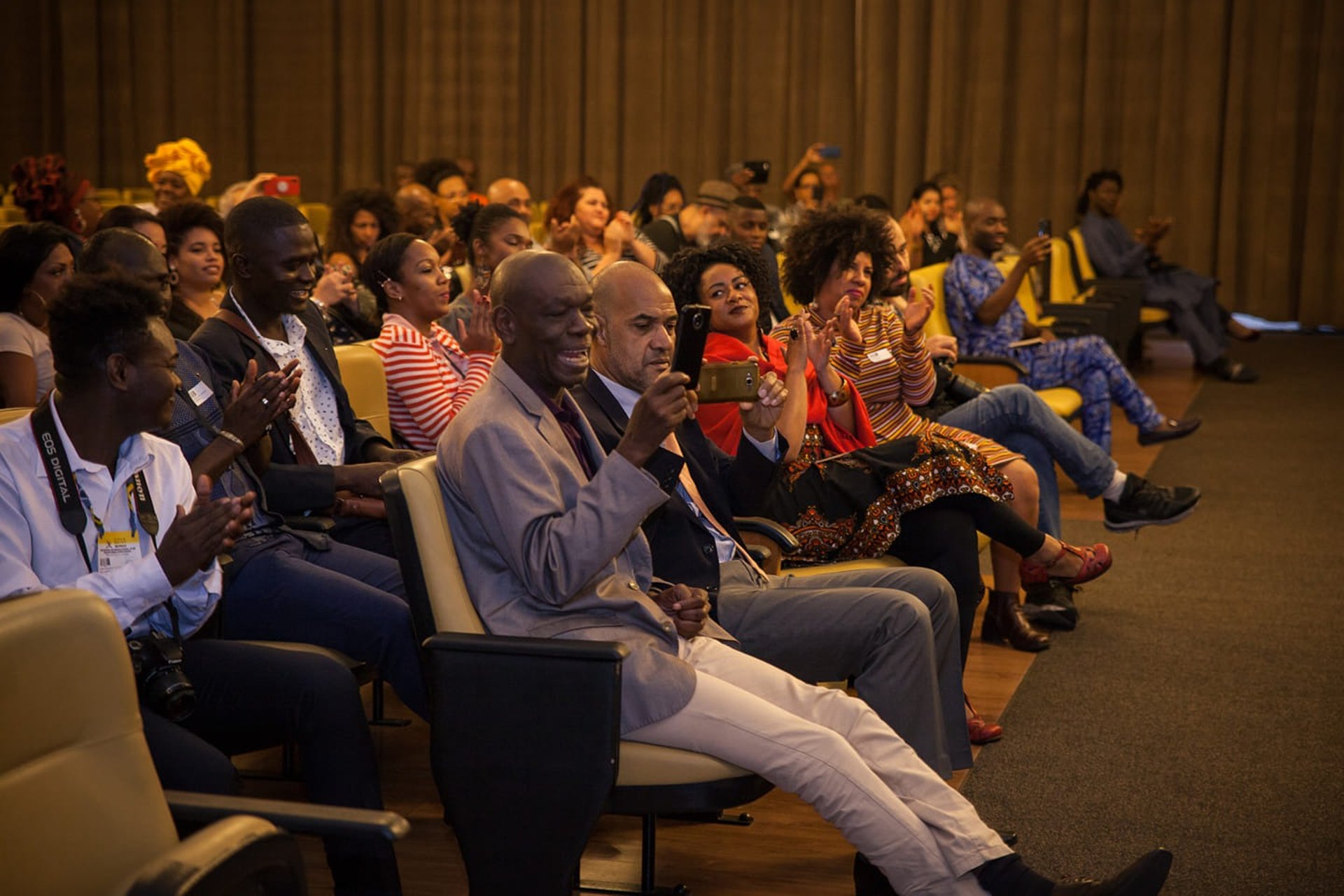 a woman sitting at a table using a laptop computer